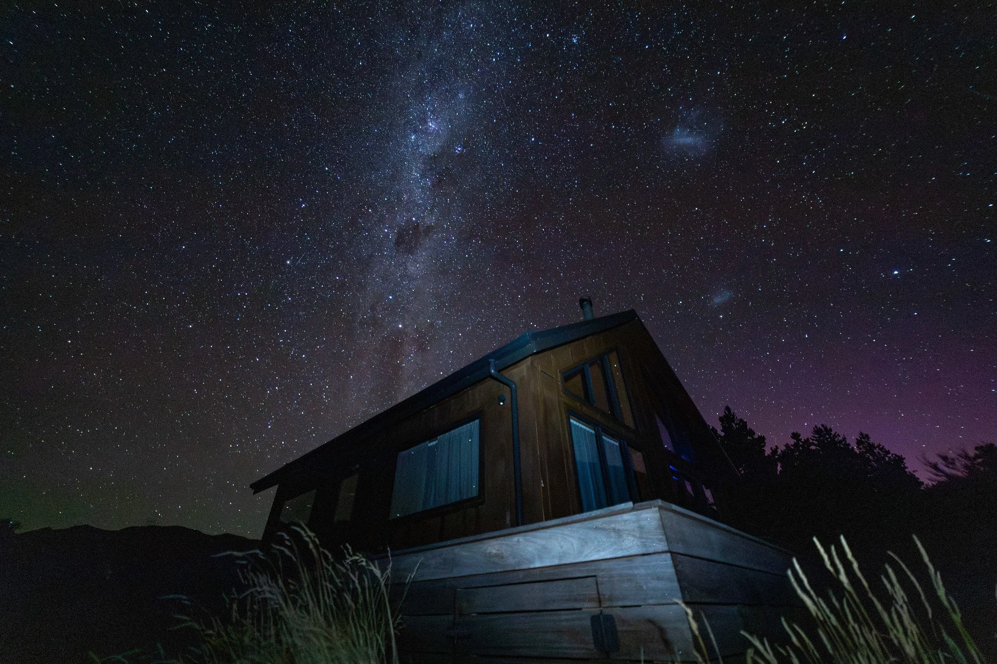 Stone church under starry night sky with Milky Way