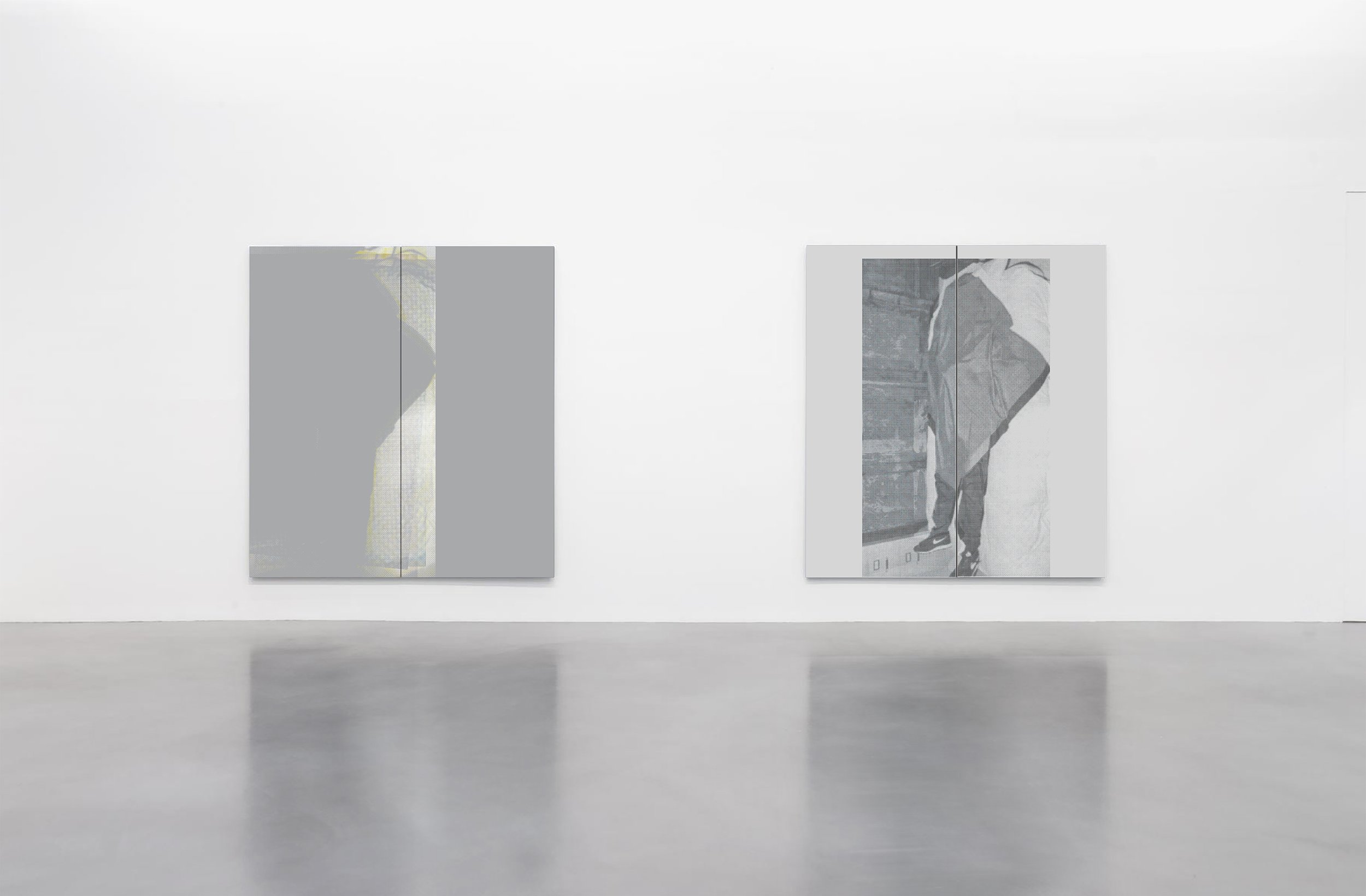 Two abstract black and white paintings displayed on a white gallery wall.