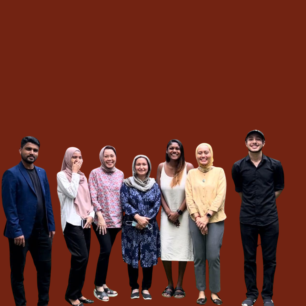 Group of seven diverse smiling people standing against a solid brown background.