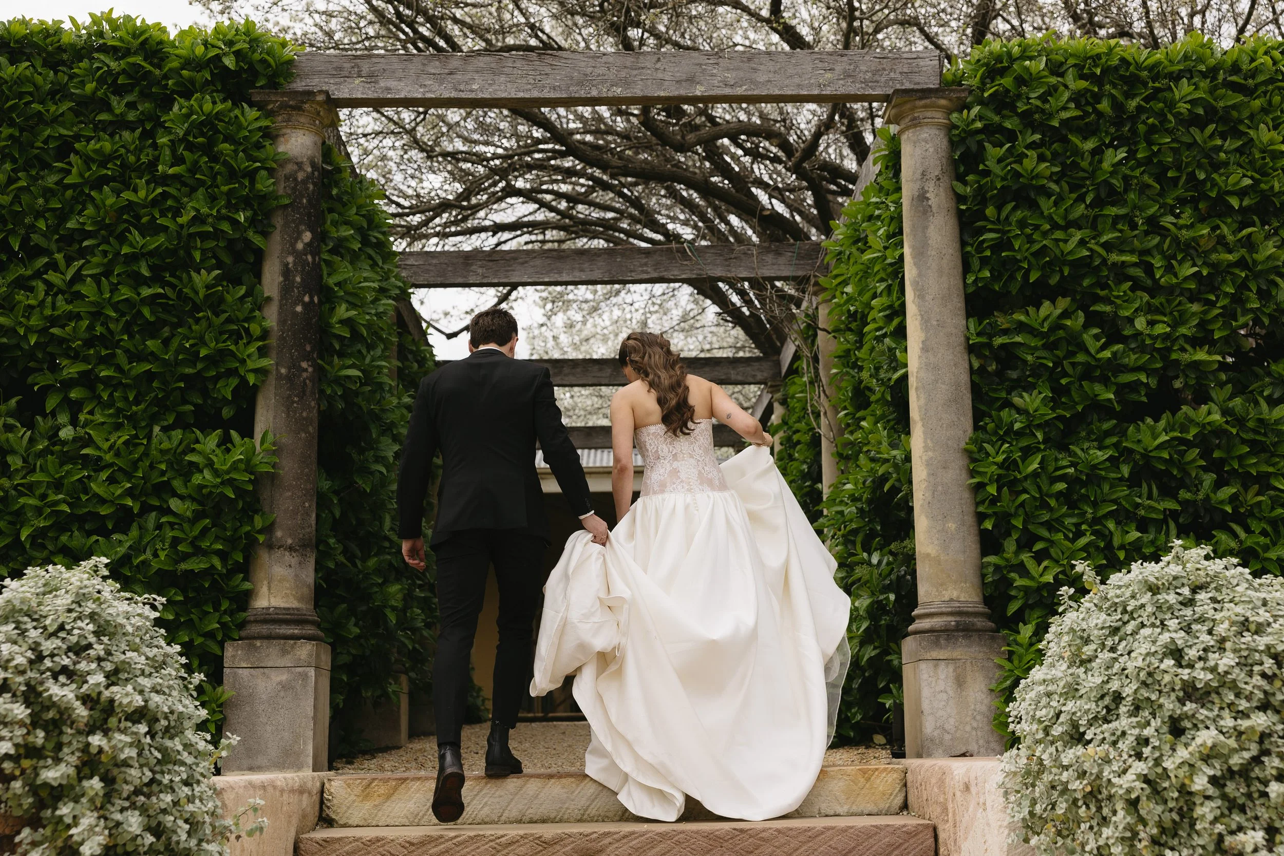Bride and groom walking away at the krinklewood venue