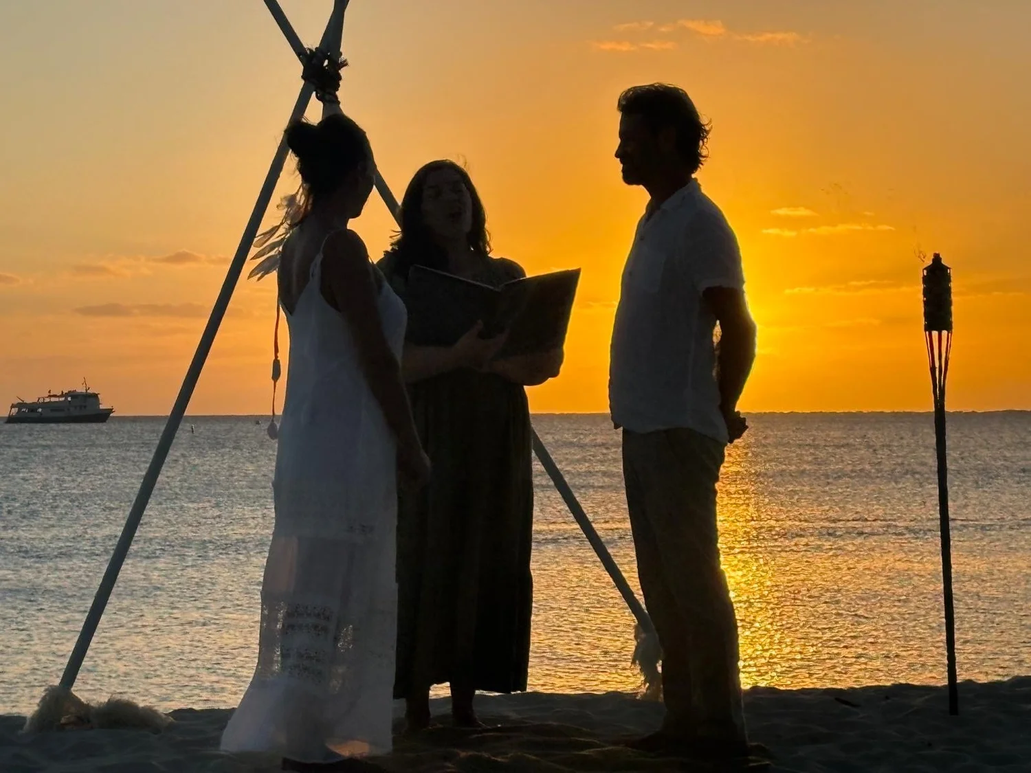 Couple exchanging vows during a golden Cayman sunset ceremony