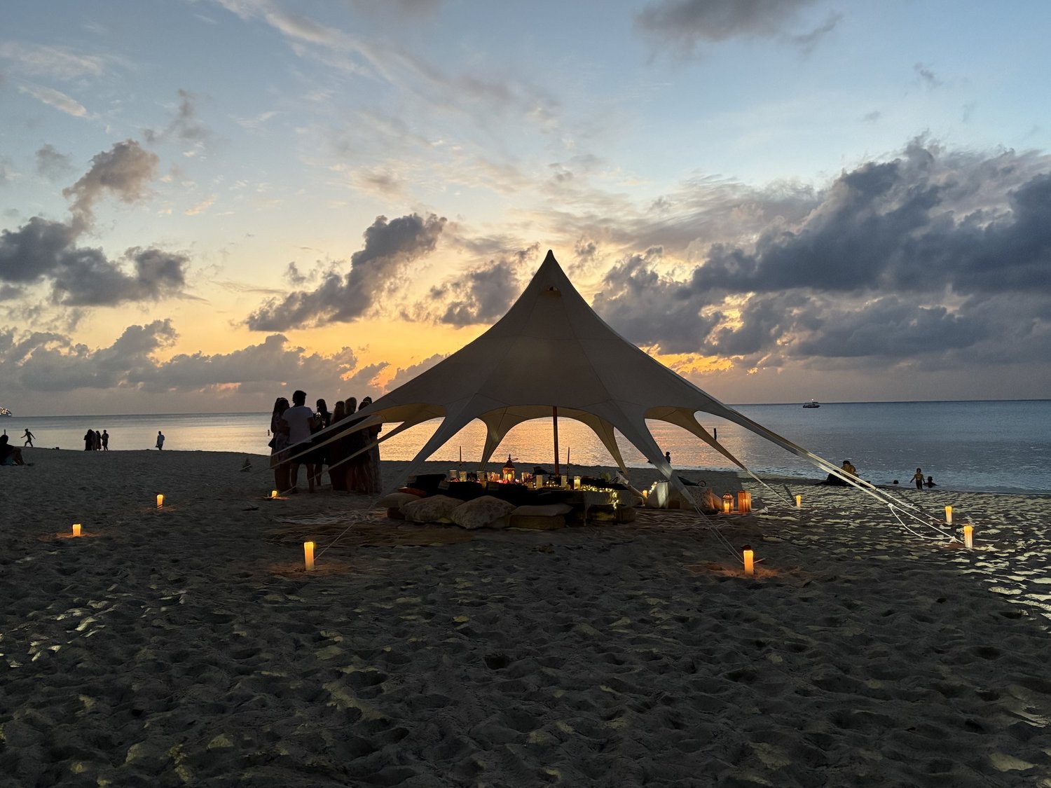 A shaded Soirées beach lounge at sunset