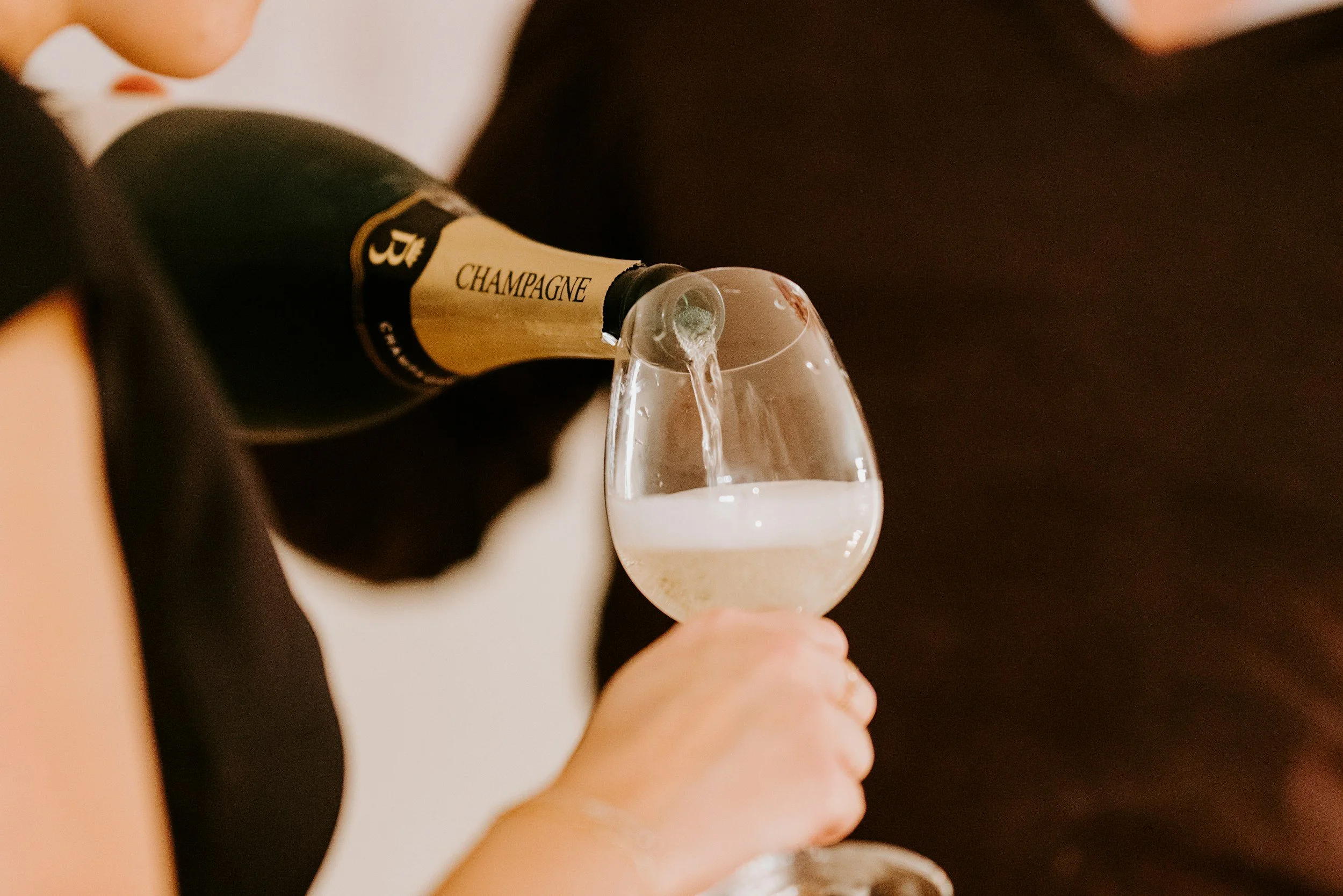pouring bottle of champagne