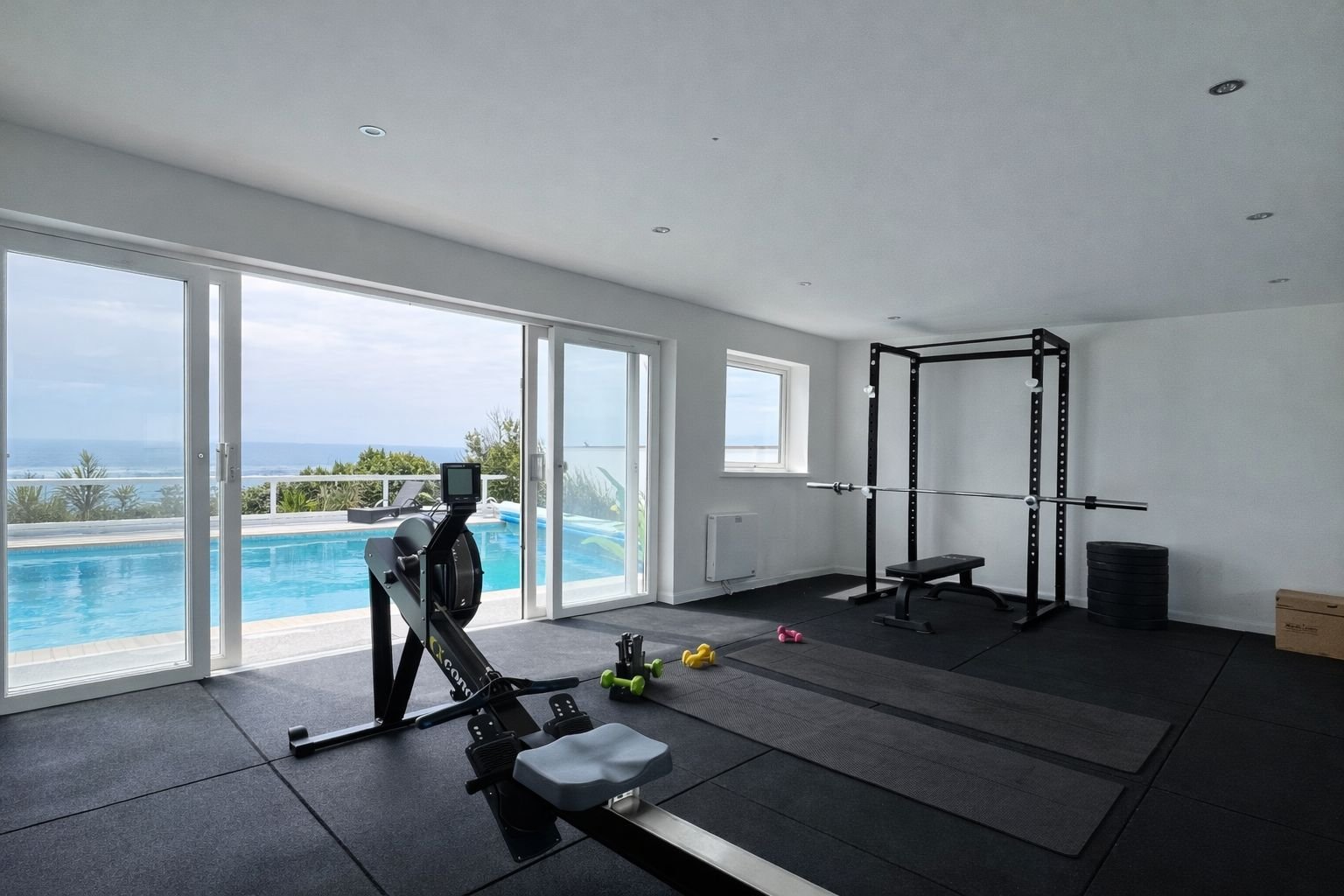 Detached gym with ocean views and equipment, shower room, and WC