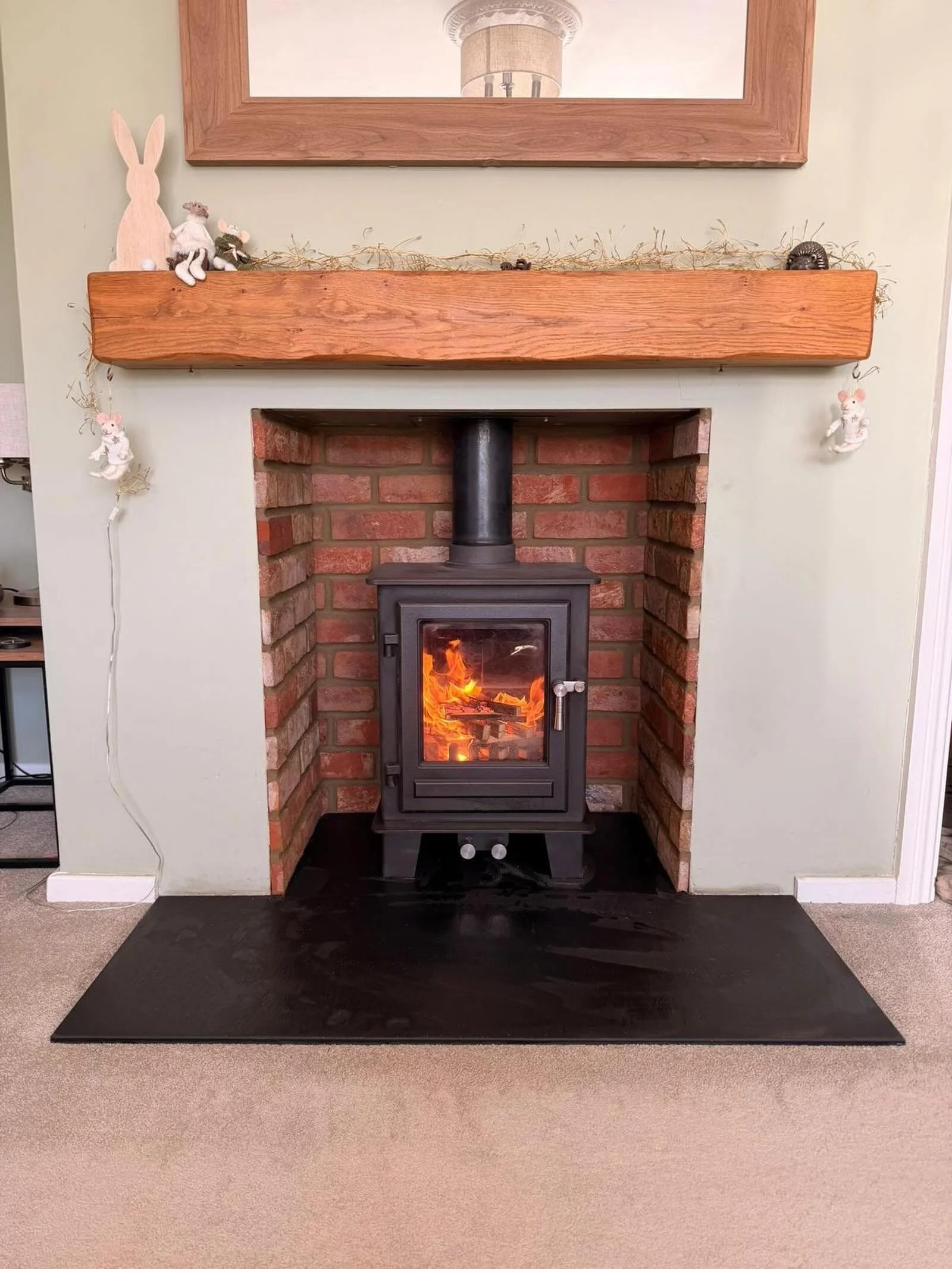 Just loving our cosy Clock Compact stove setup! 🔥

&bull;  Granite hearth
&bull;  Fireboard interior
&bull;  Beautiful wooden beam
&bull;  Original fit

A few years later we decided to upgrade the look, so we had the chamber brick-slipped for a fres