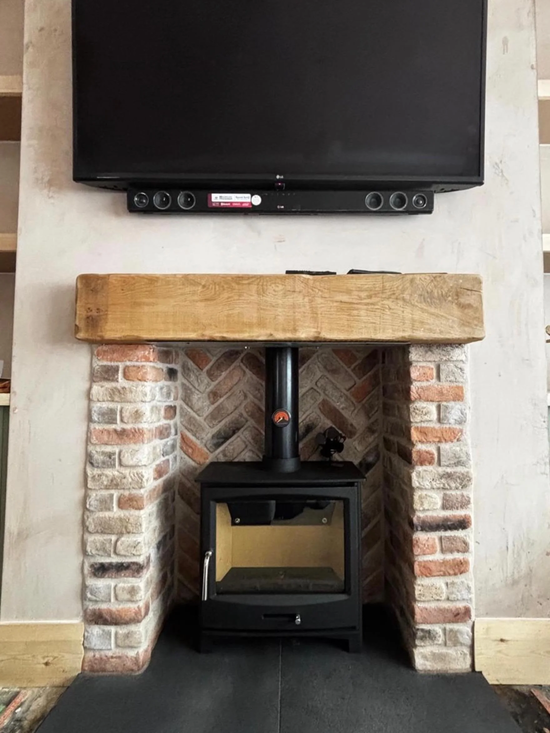 🔥 Ecosy Stove Goals Achieved! 🔥

We&rsquo;re loving how this turned out!
A sleek Ecosy wood burning stove paired with:
✅ Black stone hearth
✅ Single solid oak beam mantel
✅ Brick slip chamber in a gorgeous herringbone pattern

The perfect mix of mo