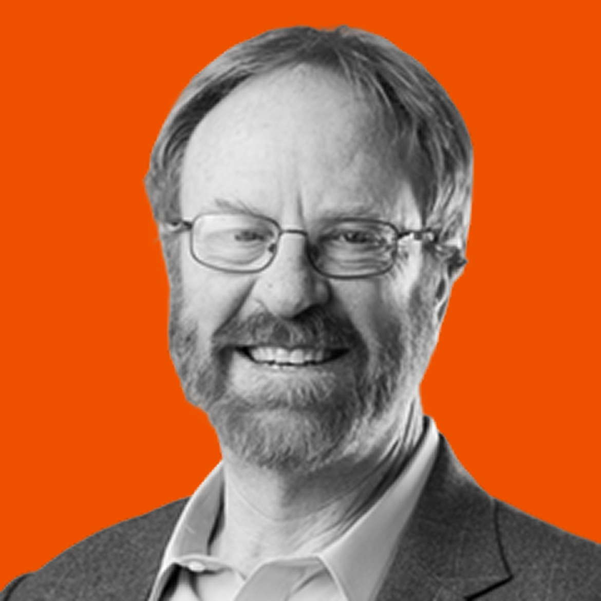 Black and white portrait of a smiling middle-aged man with glasses, a beard, and short hair, wearing a suit jacket and collared shirt, with an orange background.
