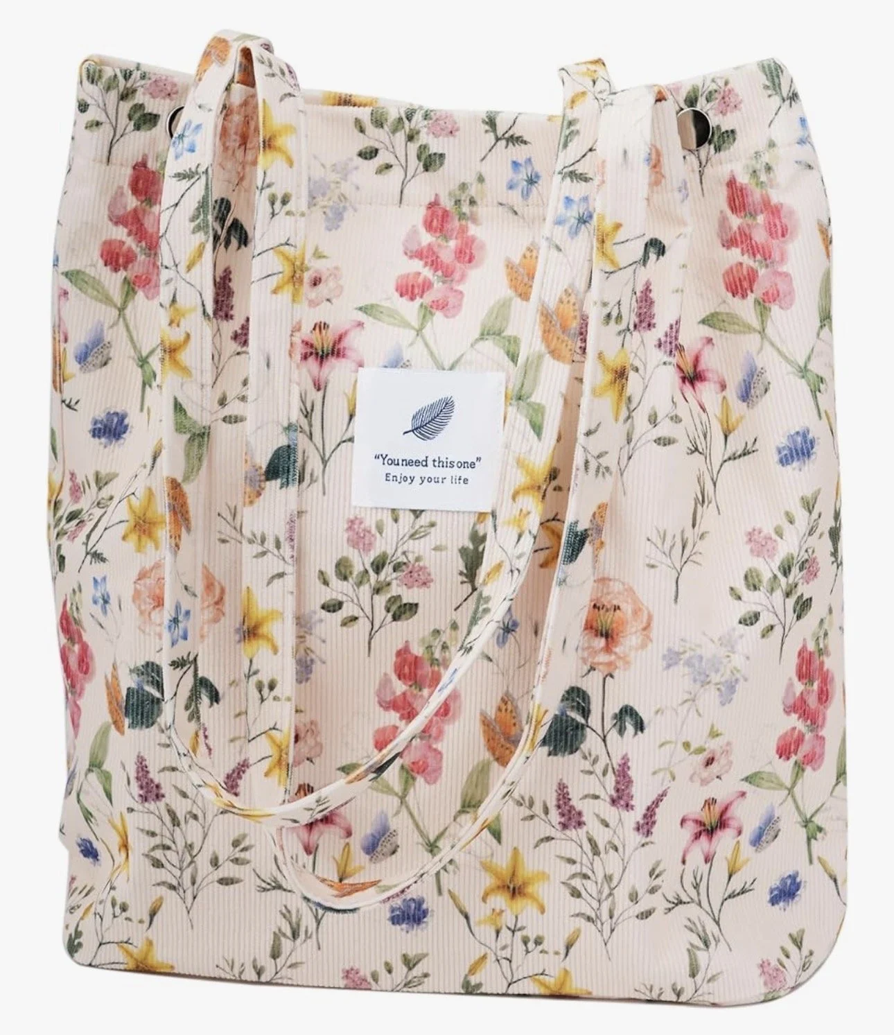 White tote bag with multicolored flowers that's great for books, notebooks, pens, and more.