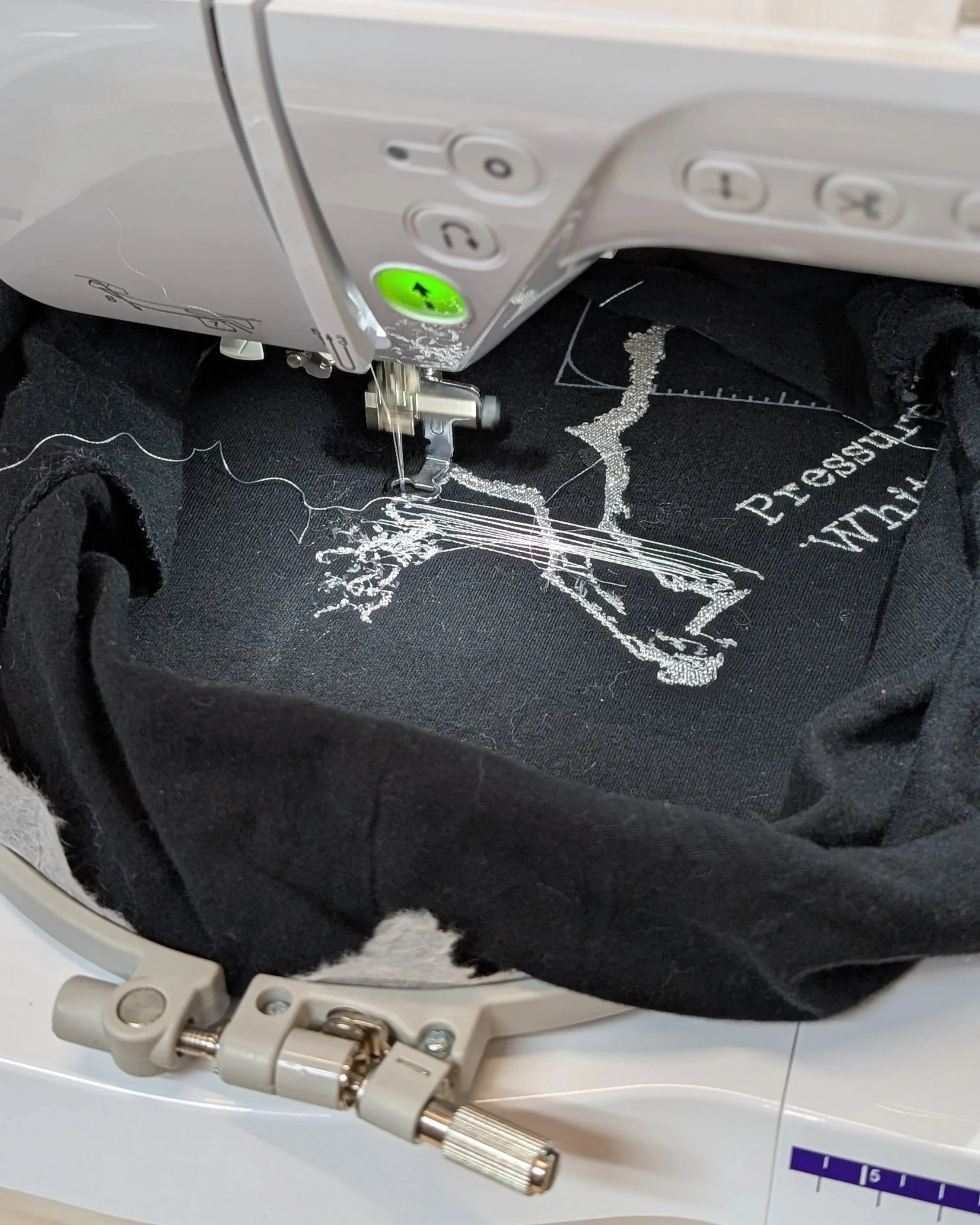 close up image of a sewing machine \embroidering on fabric