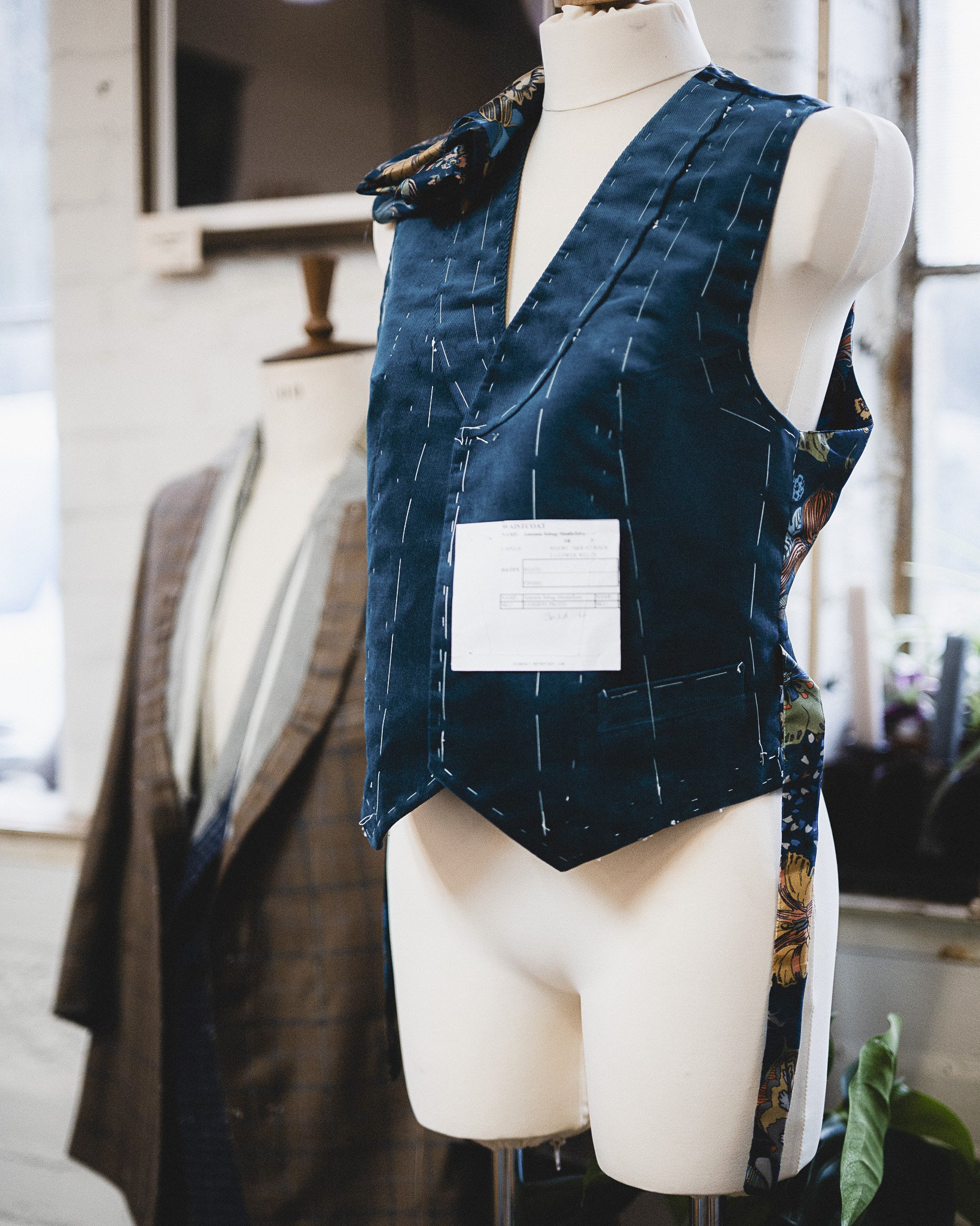 Close up of someone's hands sewing a garment which has been turned inside out