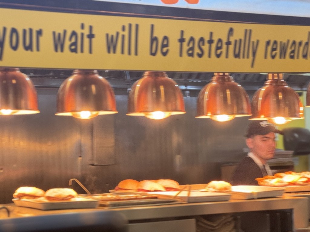 Warm-lit New York food counter evoking the atmosphere and flavor of the neighborhoods featured on the Come Hungry tour