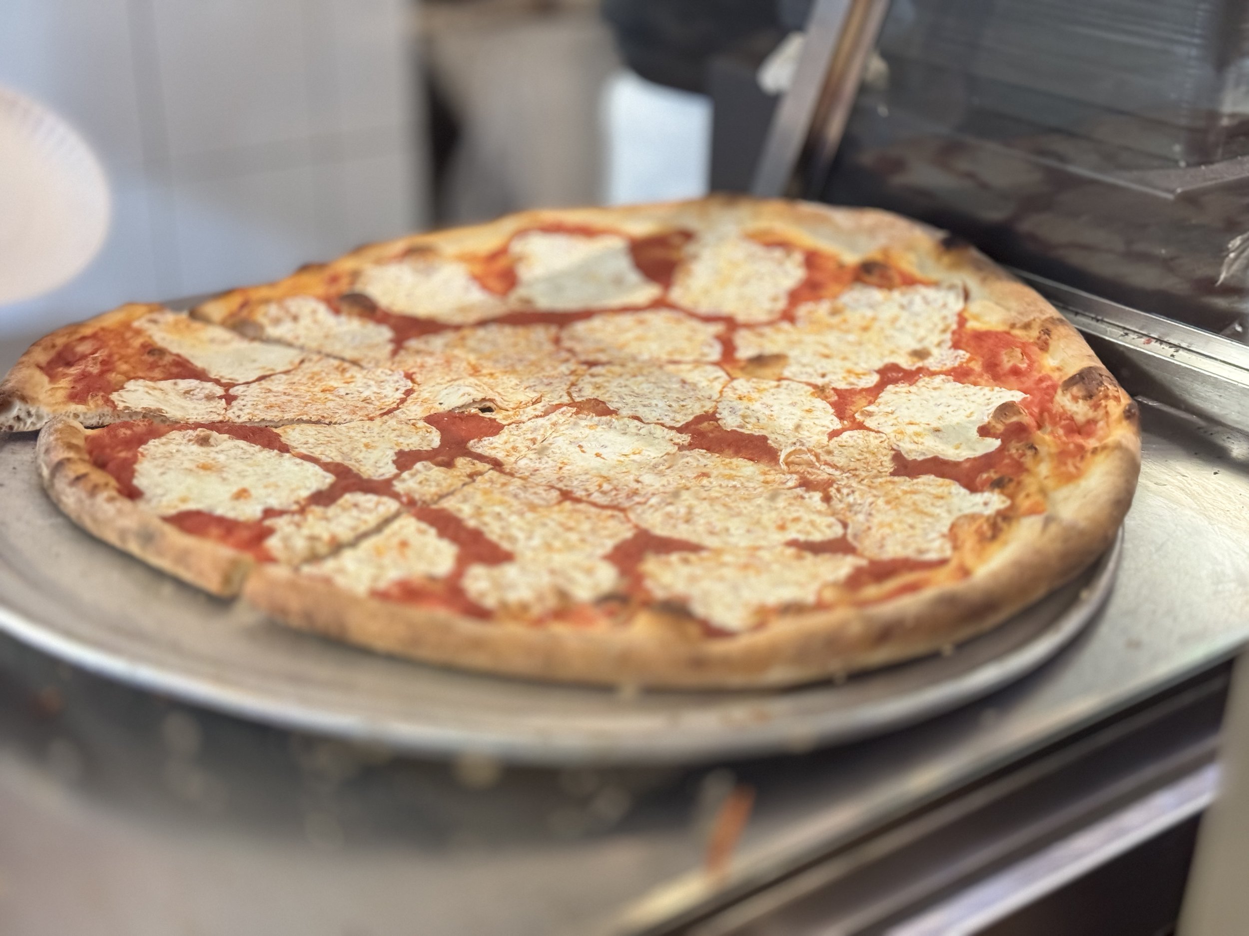 Classic New York pepperoni slice from a local pizzeria stop on the Come Hungry tour