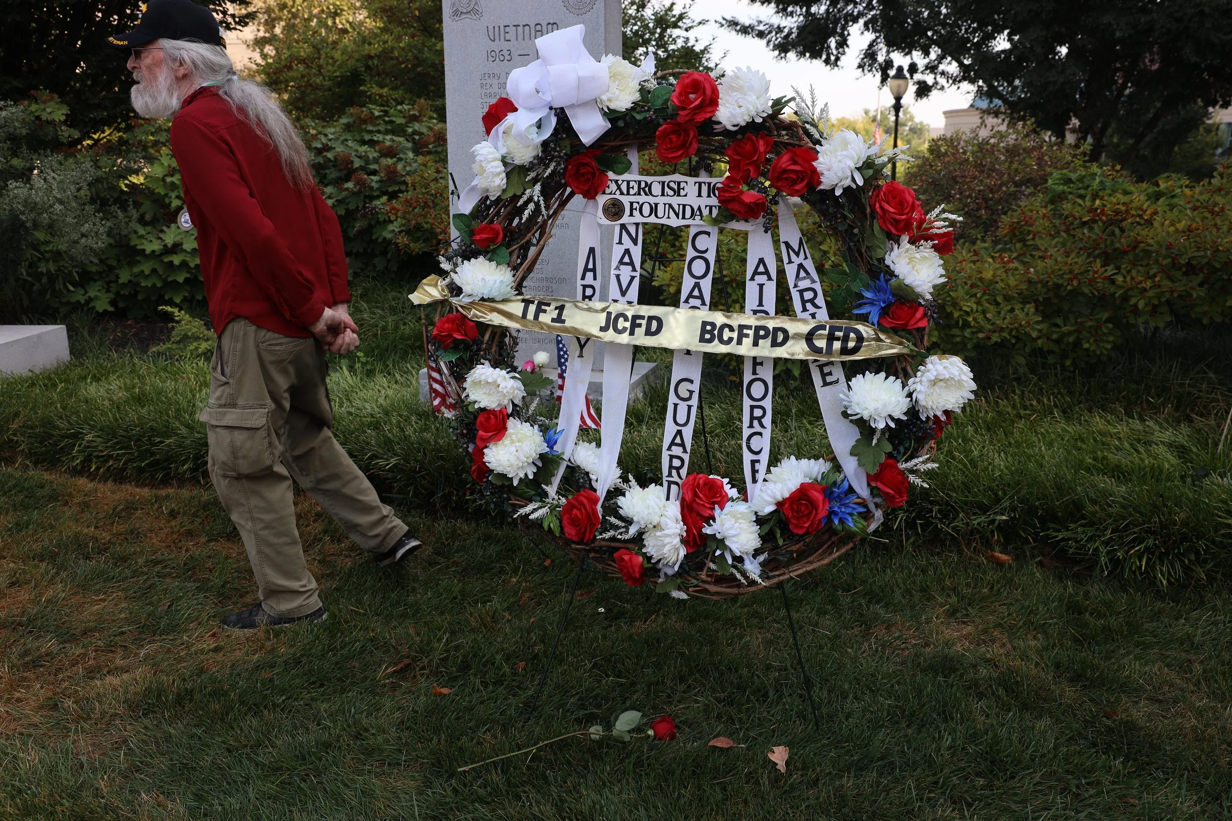 Don Jourdan, retired Veteran, lays flowers
on Thursday, Sept. 11, 2025 at the Boone
County Courthouse in Columbia. The
Exercise Tiger Association hosts the
ceremony annually to pay tribute to lives
lost during the 9/11 attacks.
