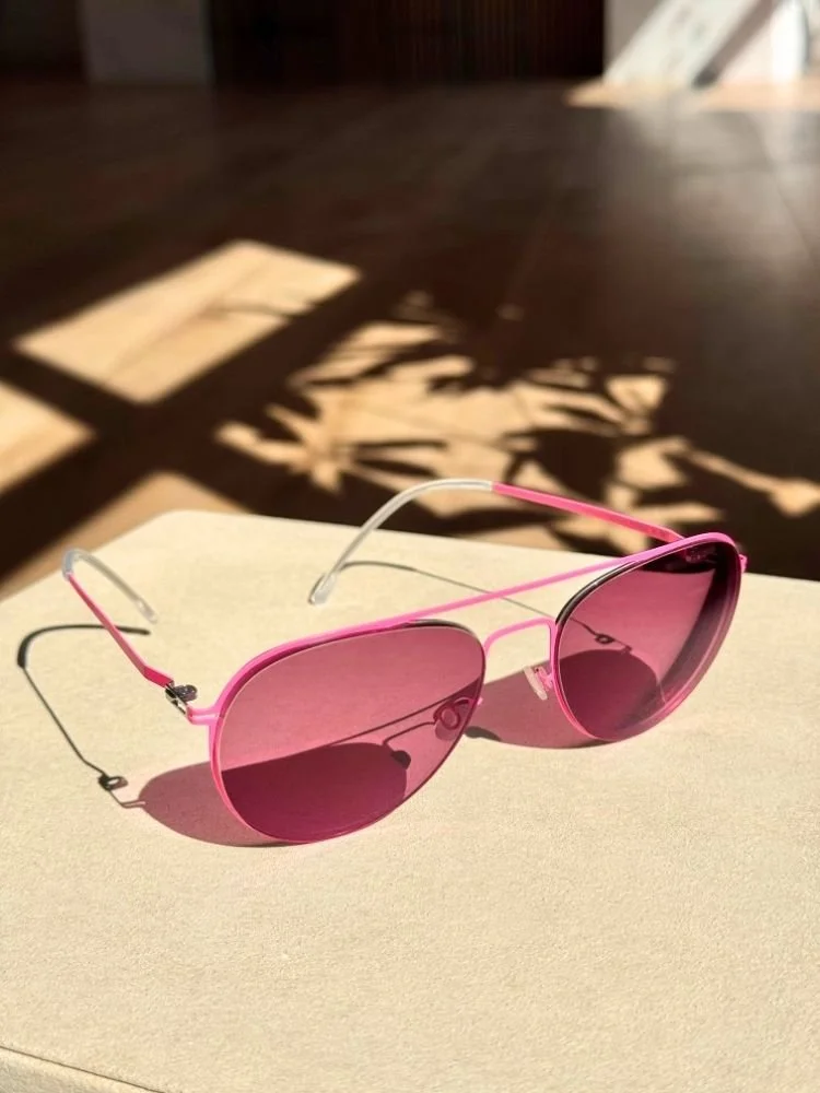 a pair of custom made pink aviator frames with pink transition lenses