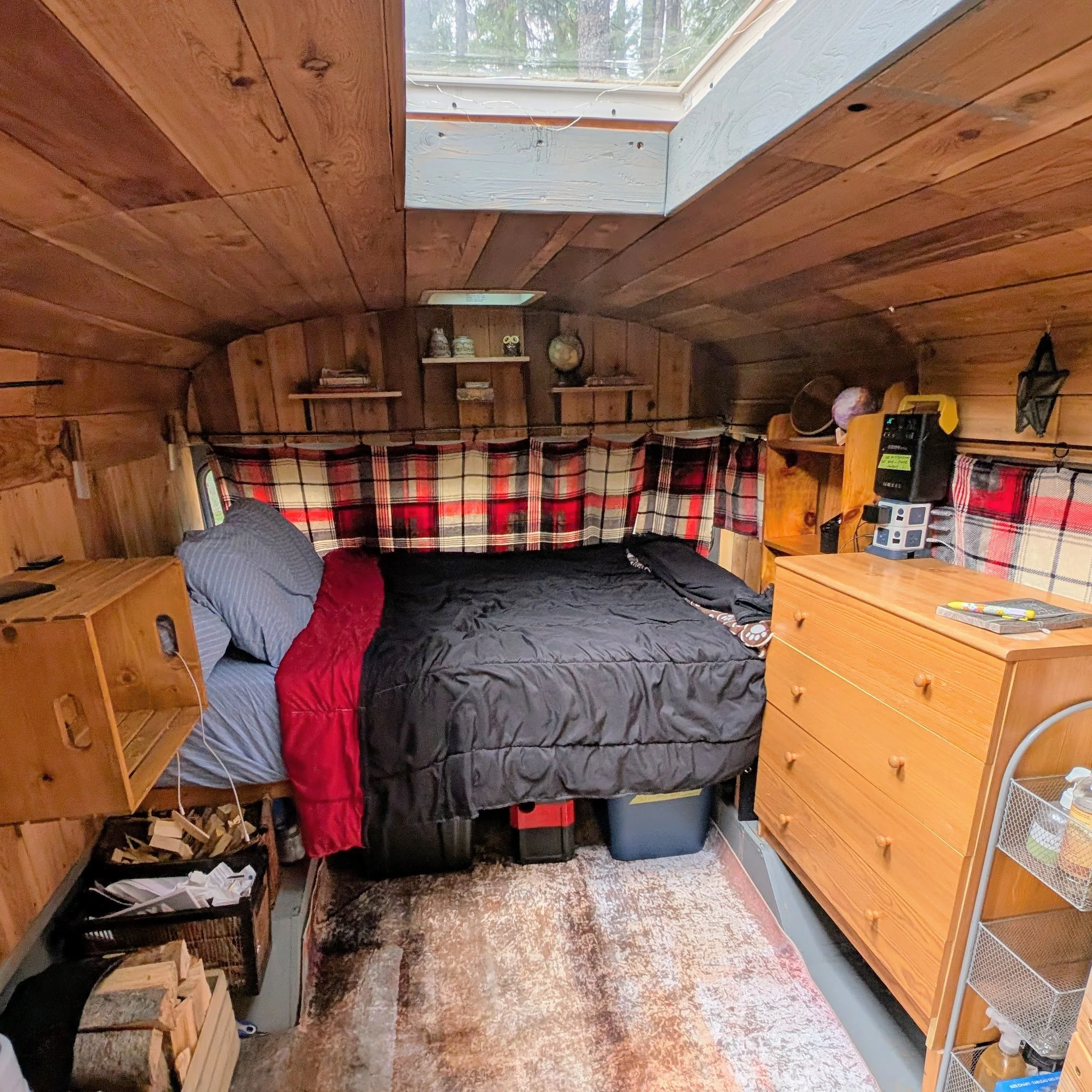 The interior of the Magic Bus, showing the bed and dresser area as well as a peak at the skylight above.