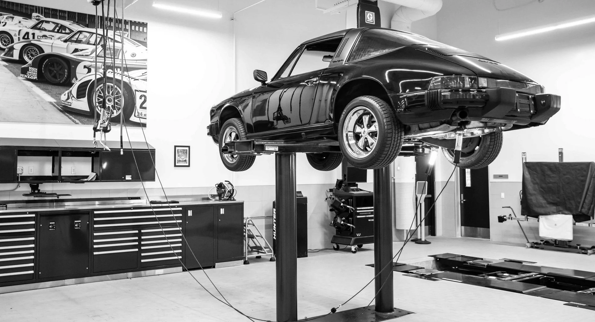 Classic Porsche 911 Targa on a lift in the 27 Motors workshop