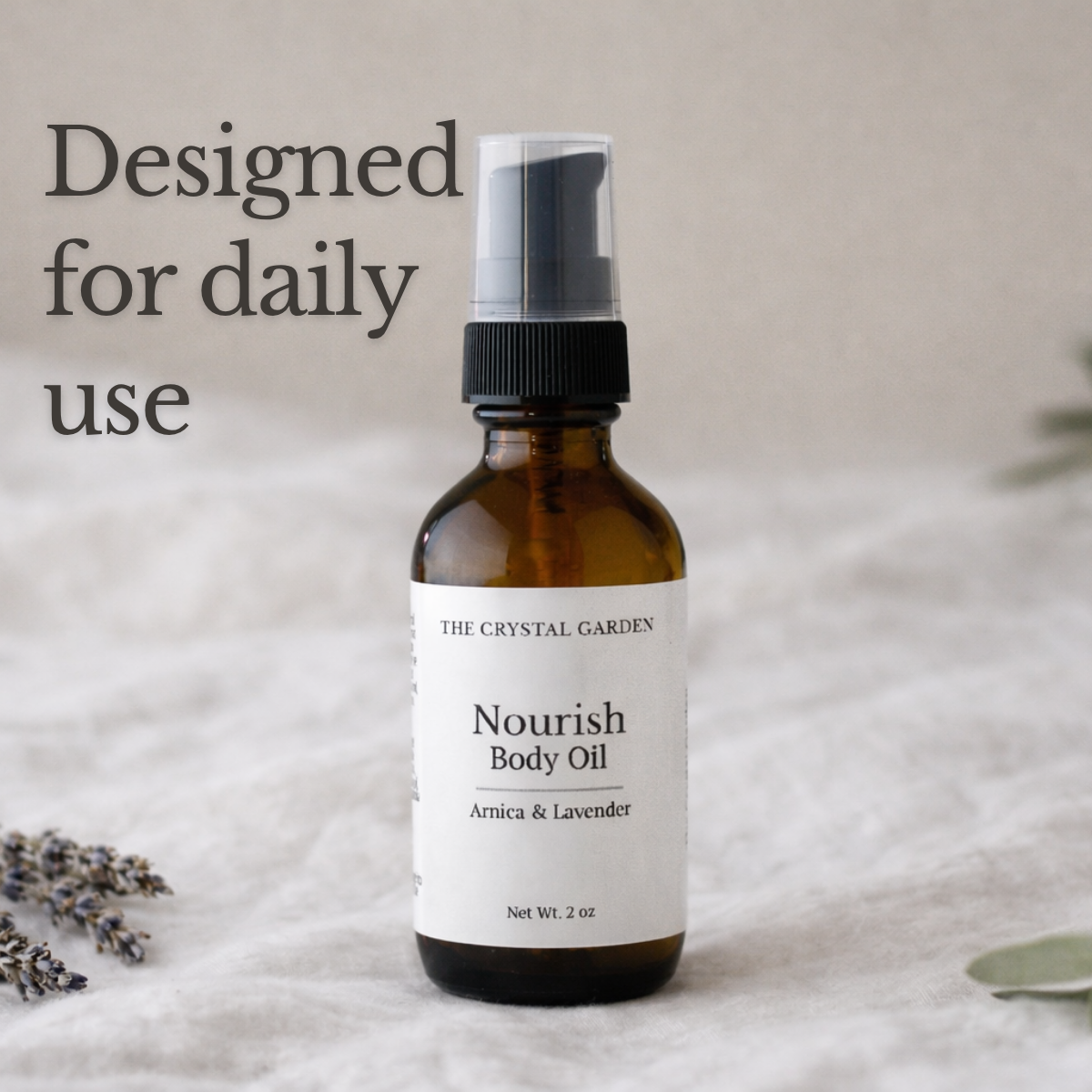 Nourish Body oil with arnica and lavender essential oils in an amber 2oz pump bottle with lavender botanicals, by The Crystal Garden