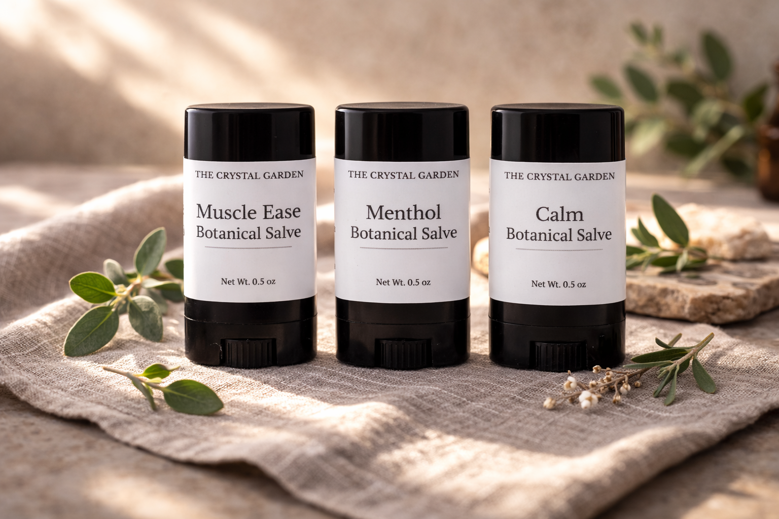 Three botanical salve tubes in a natural linen setting for plant-based topical care (Copy)