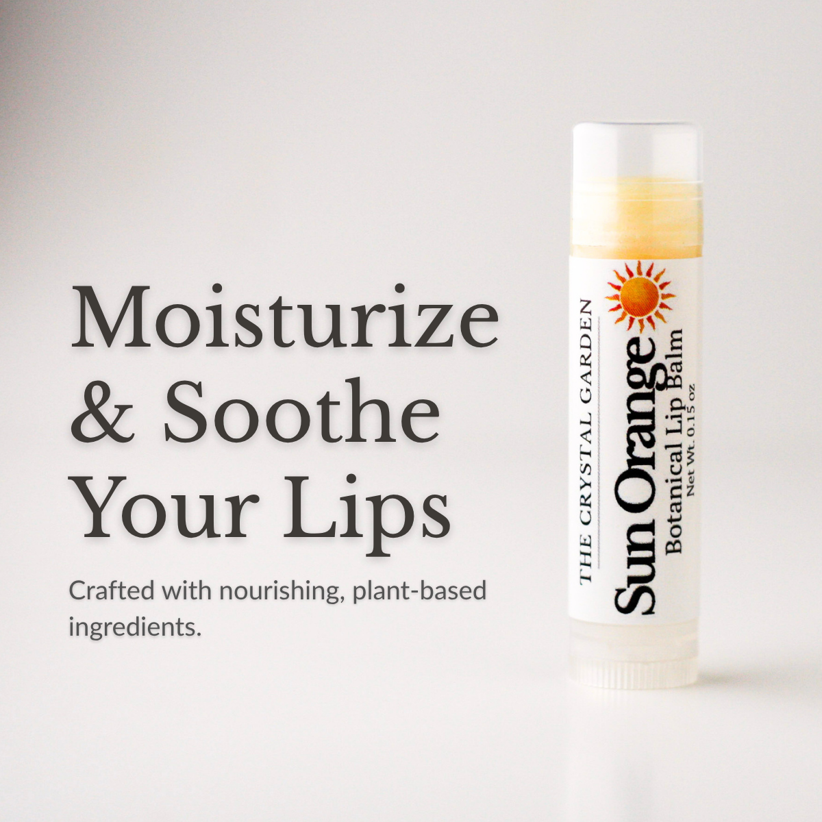 Sun Orange lip balm in white tube with botanical label on a white to light gray background., supporting photo(1).png