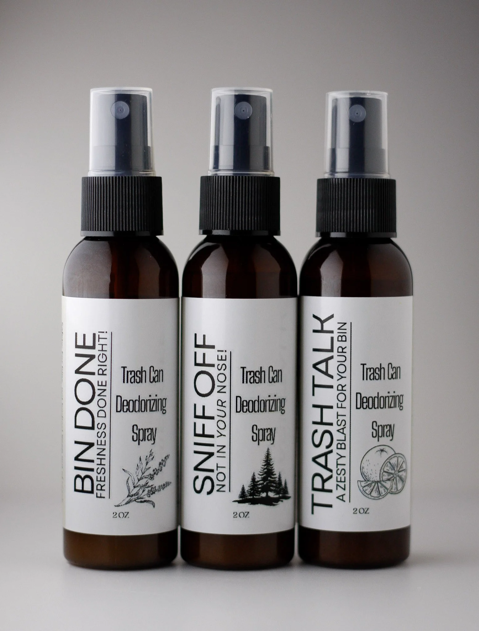 Three amber spray bottles labeled with different deodorizing sprays, including 'BINDOONE', 'SNIF OFF', and 'TRASH TALK', each with a black spray nozzle and white labels.