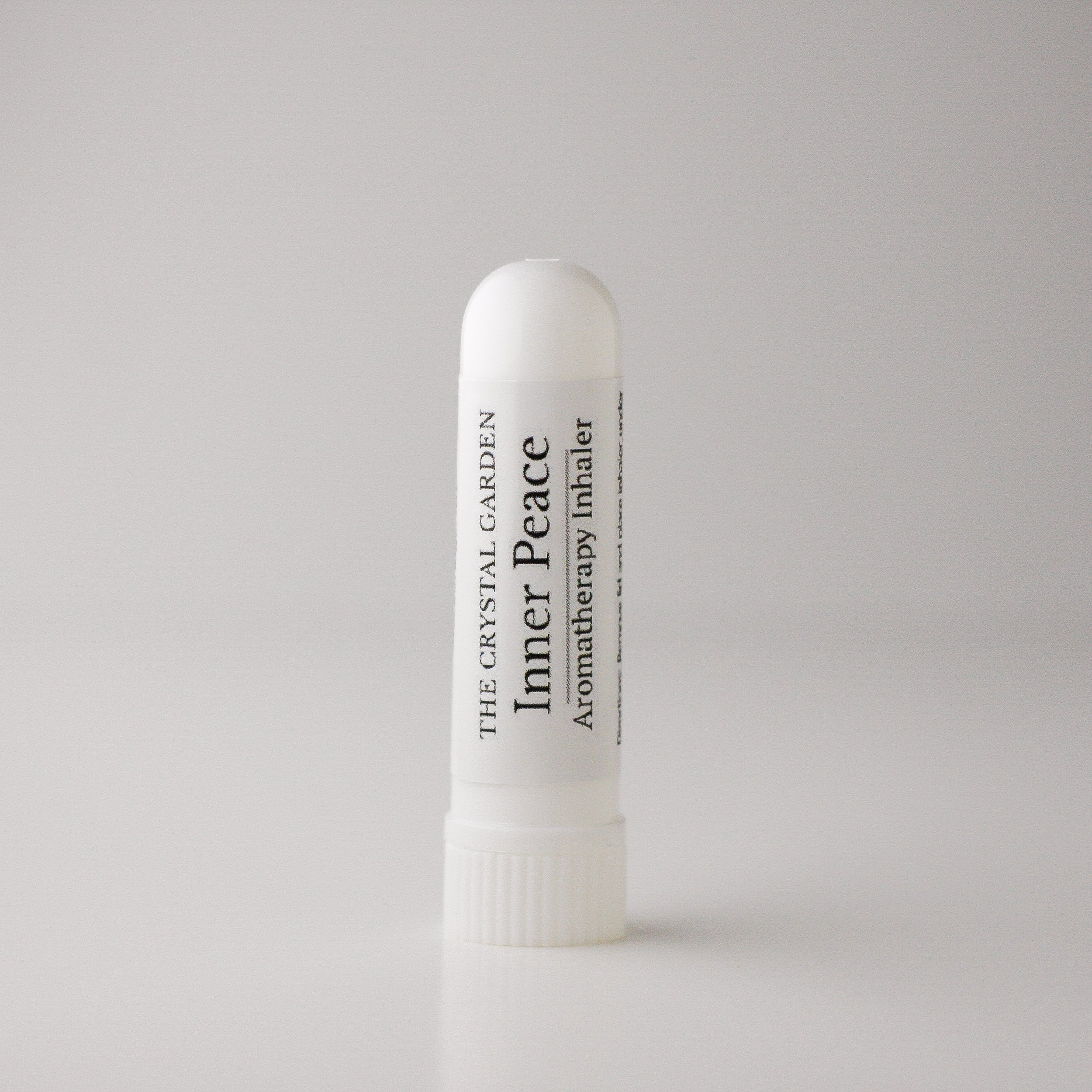  Inhaler stick labeled 'Inner Peace' with red and white packaging, standing upright on a white surface against a light gray background.