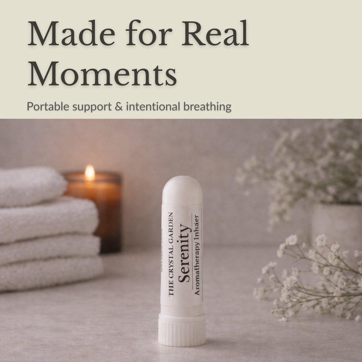 Serenity aromatherapy inhaler beside folded towels and a candle in a calm, grounding wellness setting.
