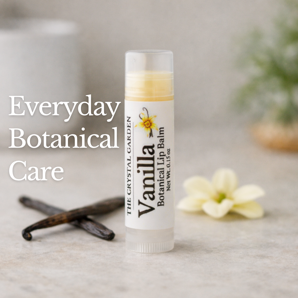 Vanilla Botanical Lip Balm on countertop with soft botanical background, plant-based lip care
