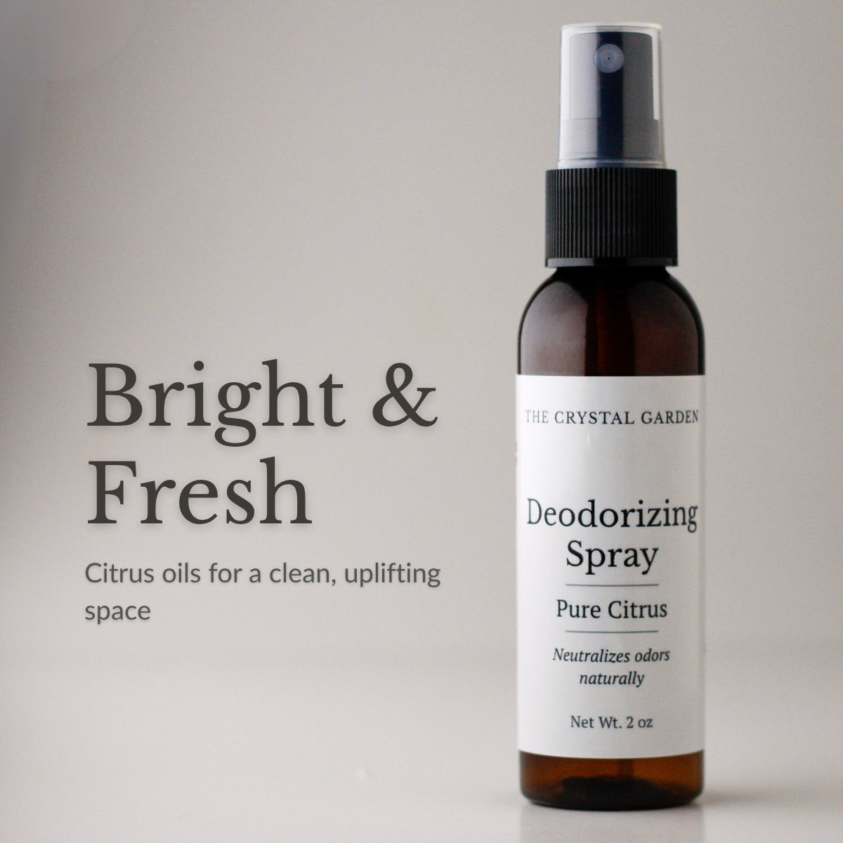 The Crystal Garden Pure Citrus deodorizing spray in a 2 oz amber bottle on a white background.