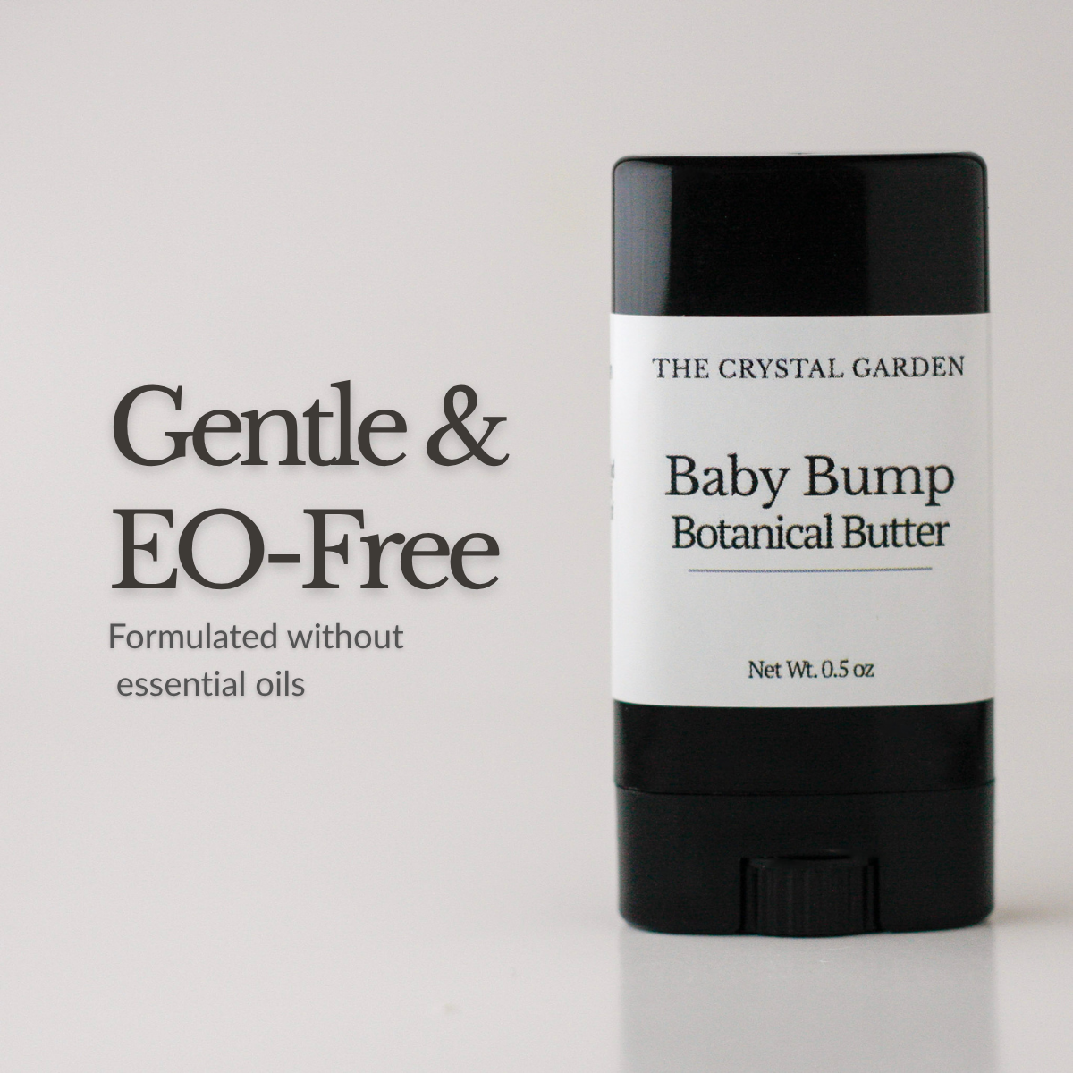 Baby Bump Botanical Butter pregnancy belly butter in a black twist-up tube with minimalist label on a white background., Essential oil free text