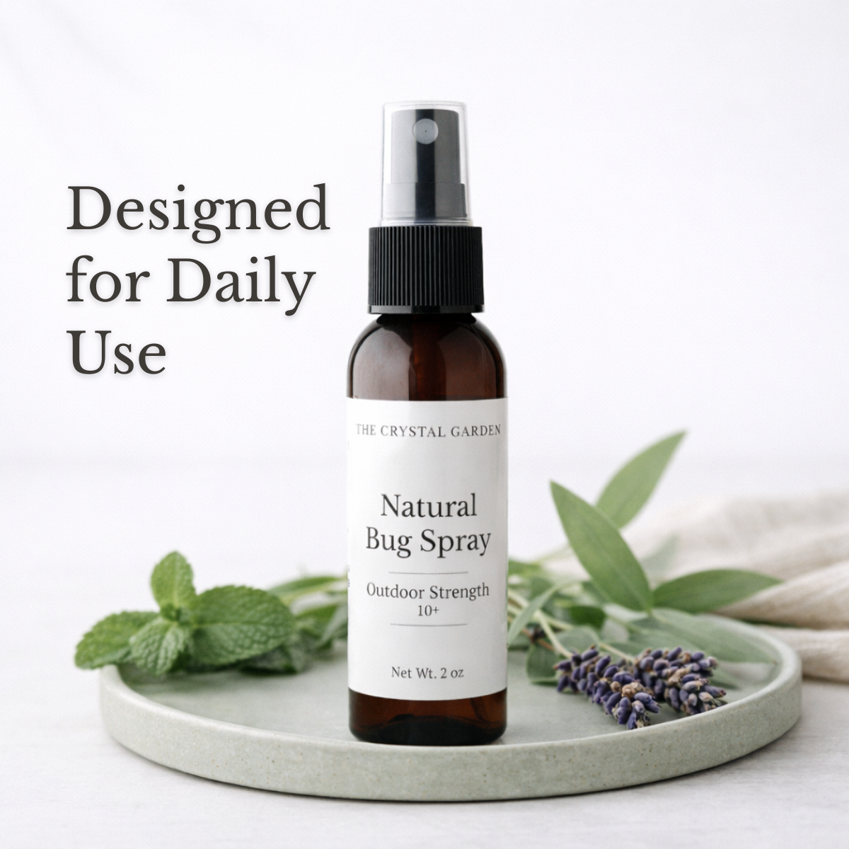 Plant-based natural bug spray bottles from The Crystal Garden shown outdoors for seasonal outdoor use