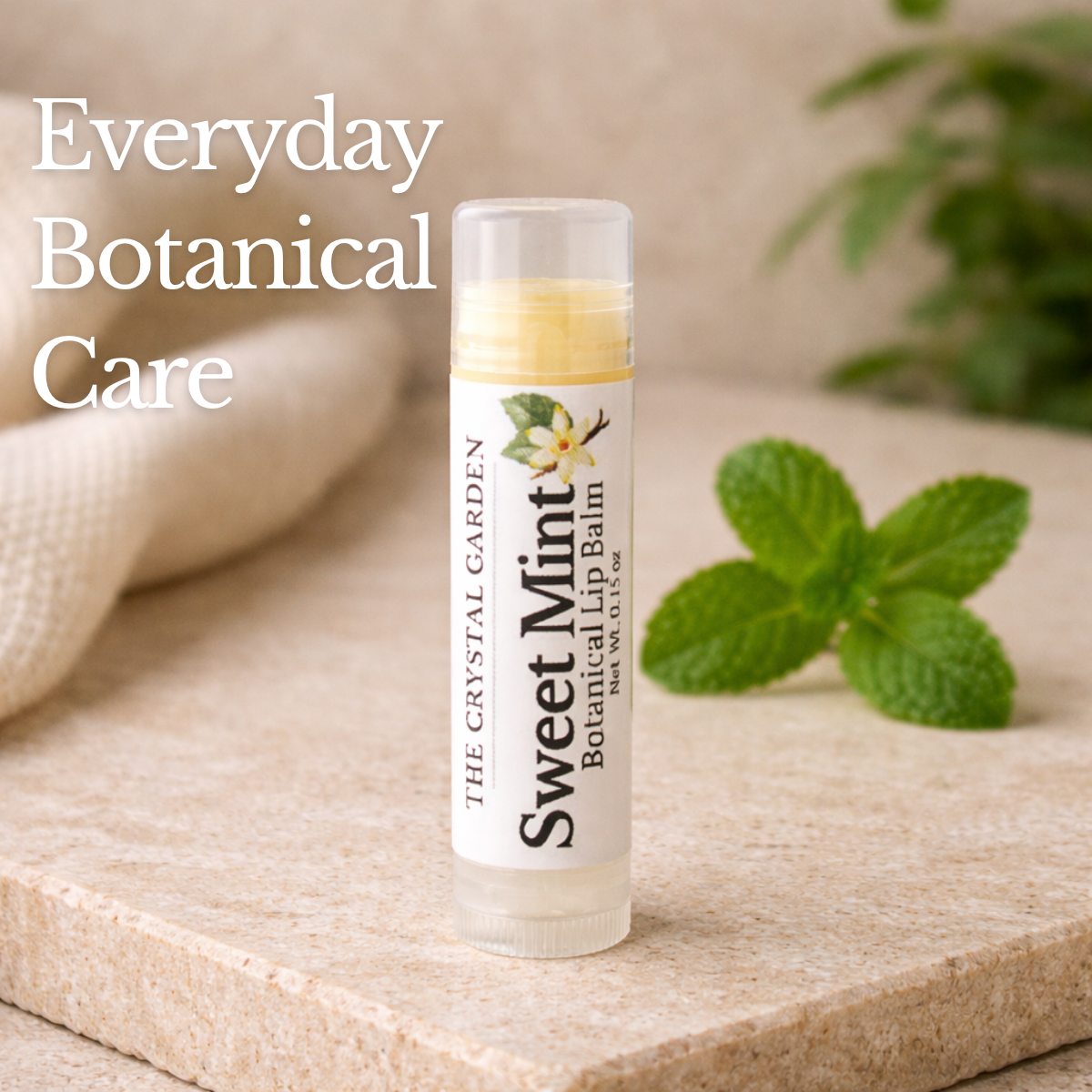 Sweet Mint lip balm on a stone surface with mint leaves and soft neutral background.