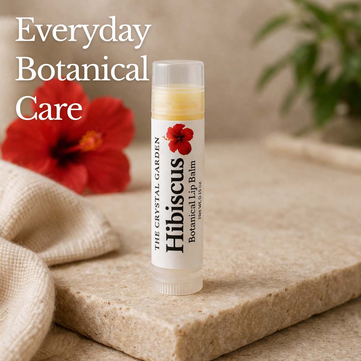 Hibiscus Botanical lip balm on a stone surface with hibiscus flower and soft neutral background.