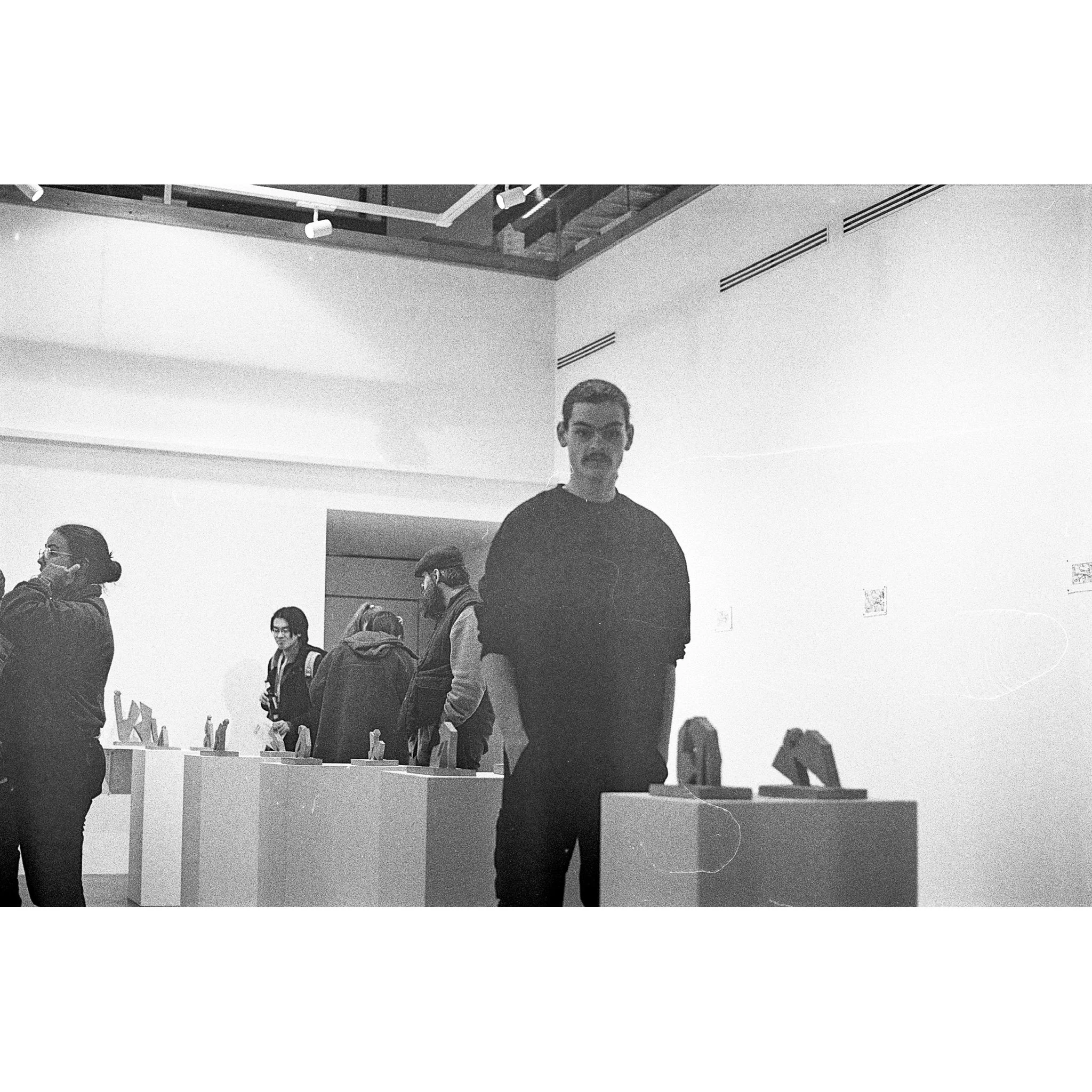 Photograph of Izatt Shortman at the private view of 'Izatt Shortman, Harry Wilkins' at Michael Pennie Gallery, Bath, 2024. © Jakub Knap, 2024