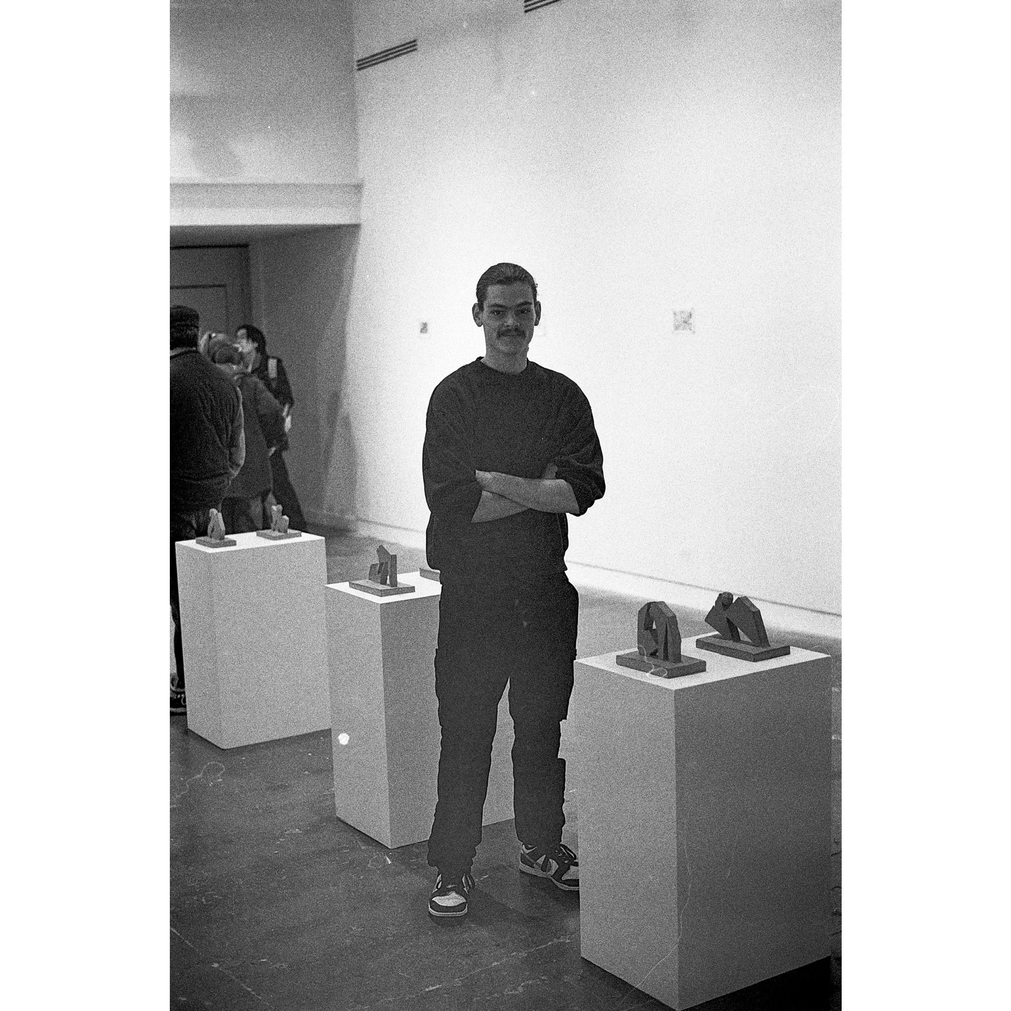 Photograph of Izatt Shortman at the private view of 'Izatt Shortman, Harry Wilkins' at Michael Pennie Gallery, Bath, 2024. © Jakub Knap, 2024