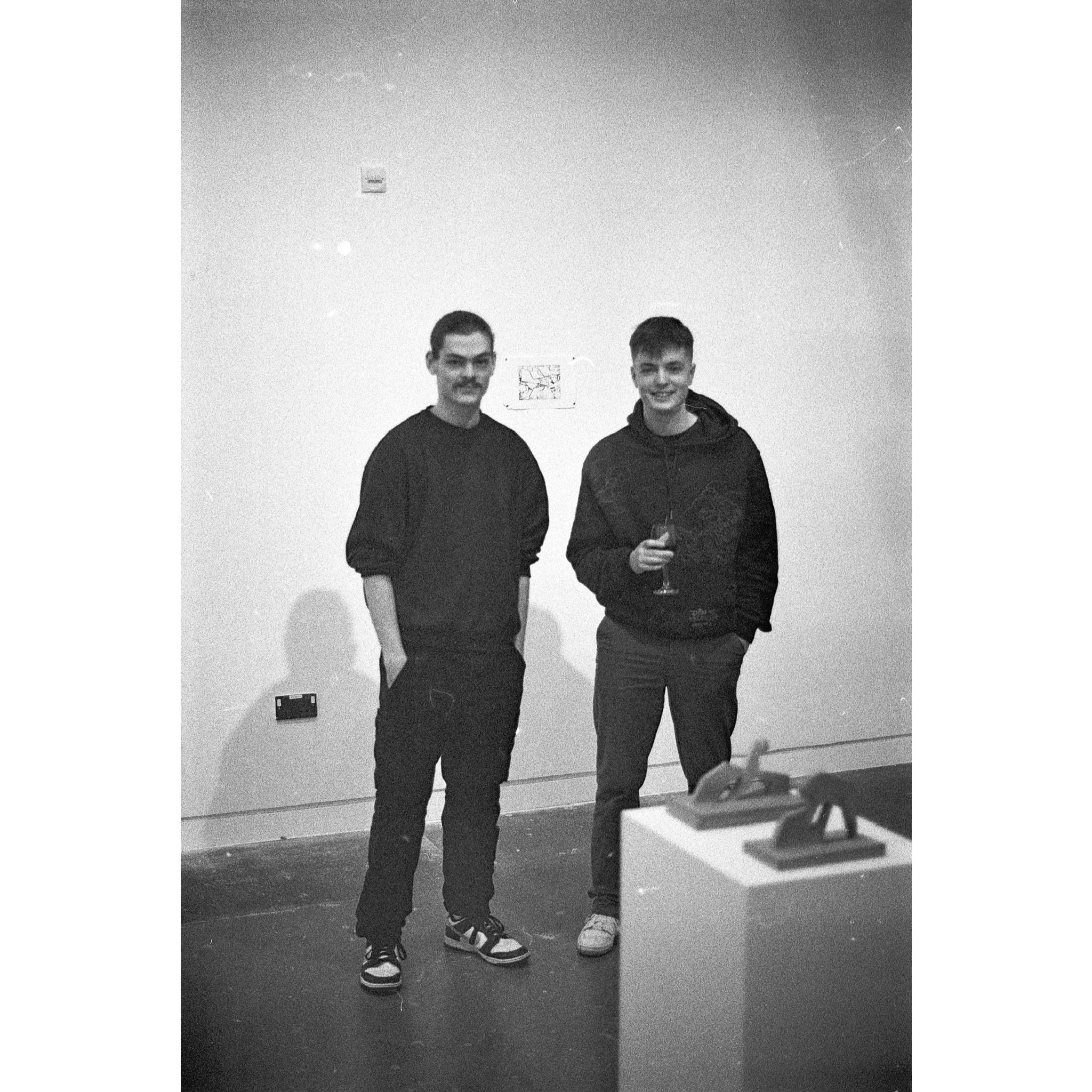 Photograph of the two artists at the private view of 'Izatt Shortman, Harry Wilkins' at Michael Pennie Gallery, Bath, 2024. © Jakub Knap, 2024