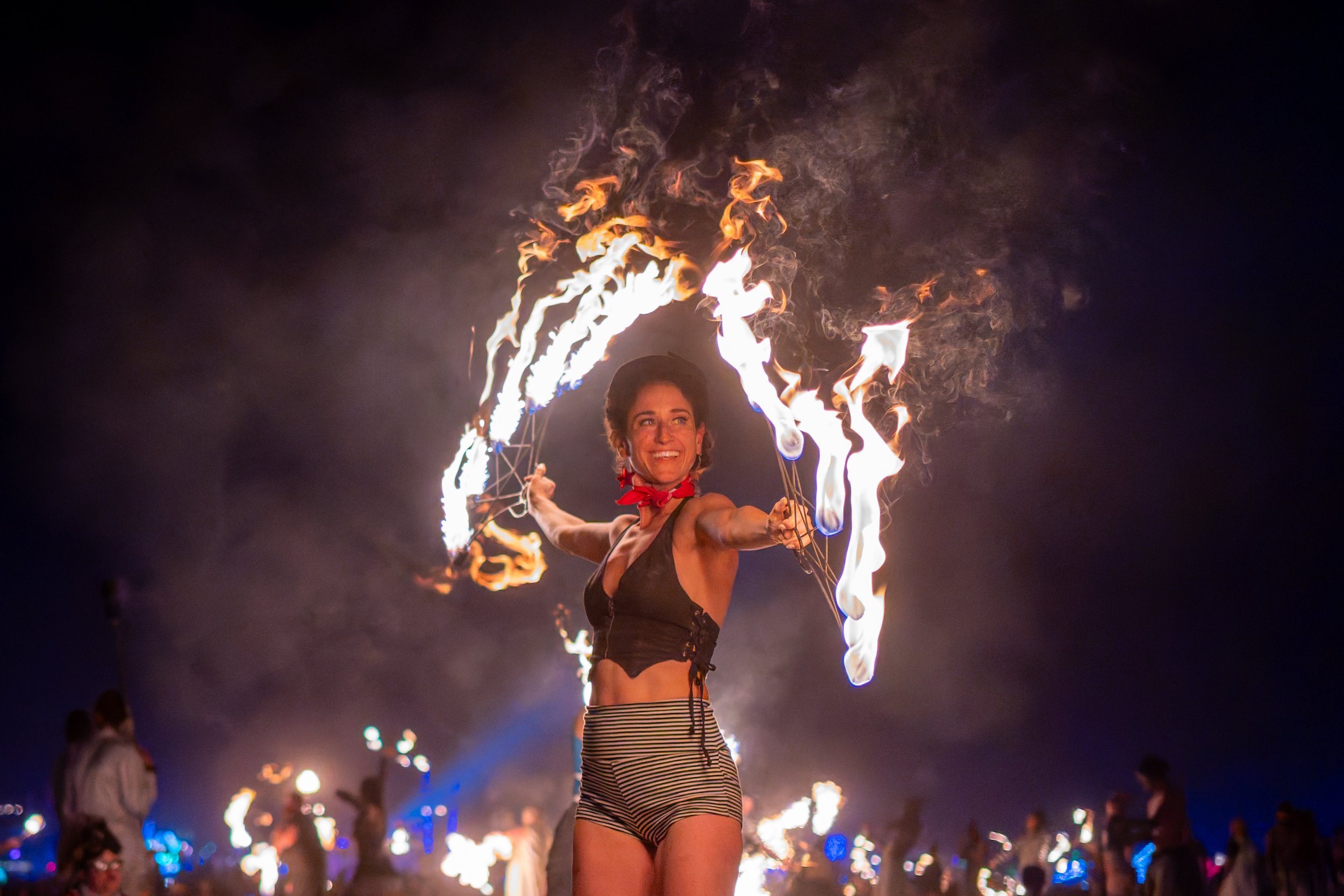 A DJ's hand adjusting controls on a green-lit DJ mixer or turntable.