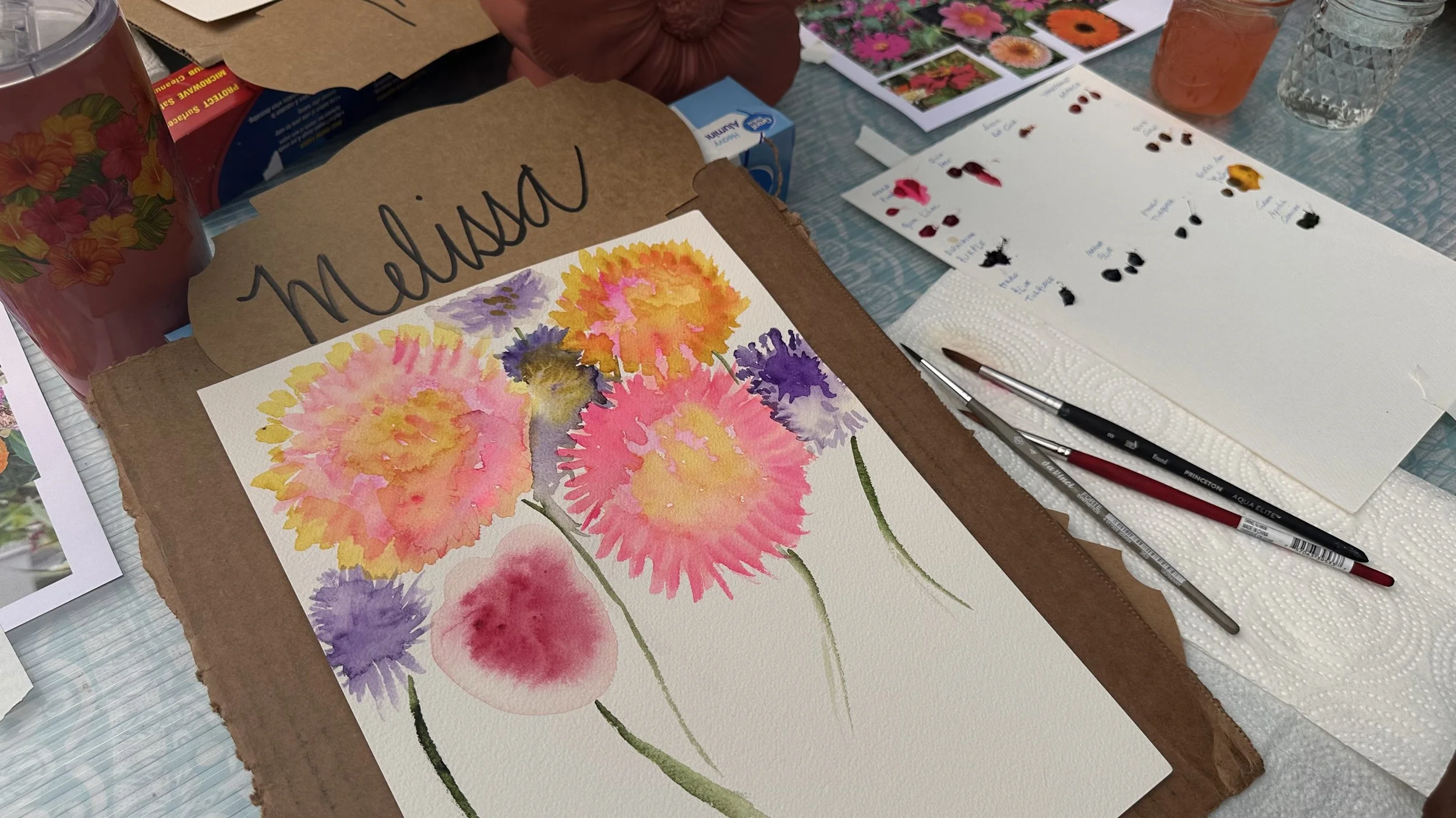 A watercolor painting of colorful flowers on paper, with art supplies and reference images nearby, labeled 'melisa' at the top.