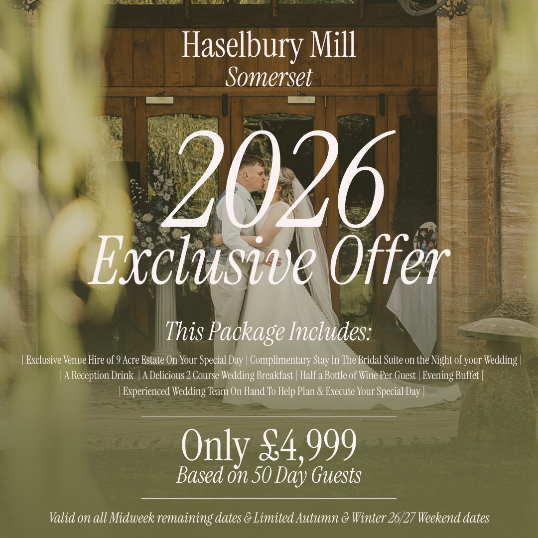 Wedding couple kissing in front of a wooden barn door at Haselbury Mill in Somerset, advertising a 2026 wedding package.
