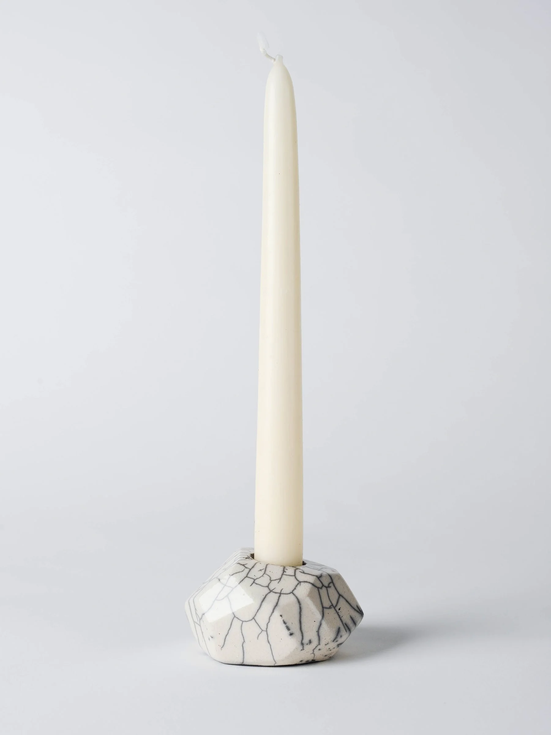 Raku-Kerzenständer mit eingesetzter Kerze, sichtbar die Glanzpunkte und die rauchgezeichnete Oberfläche