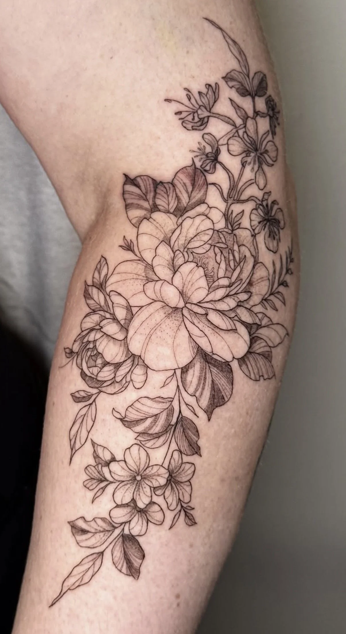 Flower fine line tattoo on arm