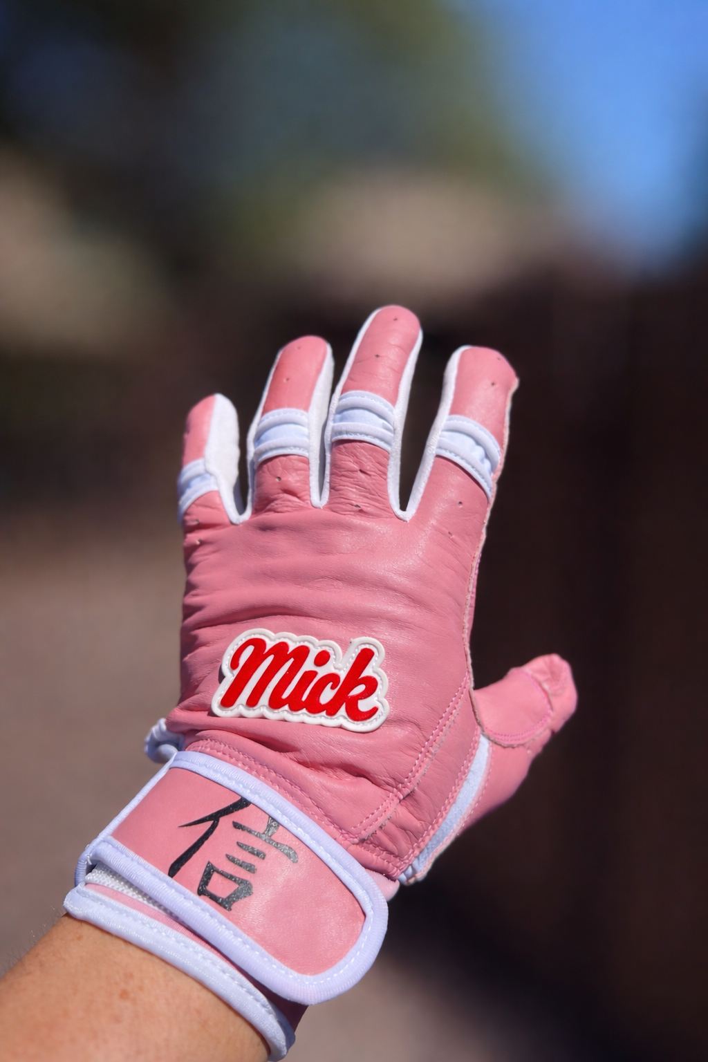 Pink sports glove with _Mick_ detail.png