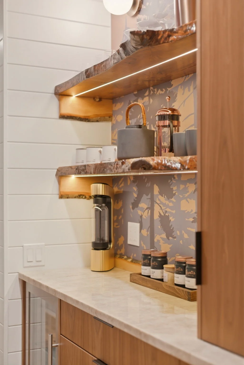 Coffee bar with forest wallpaper and live-edge maple shelf at Fjellsangin cabin