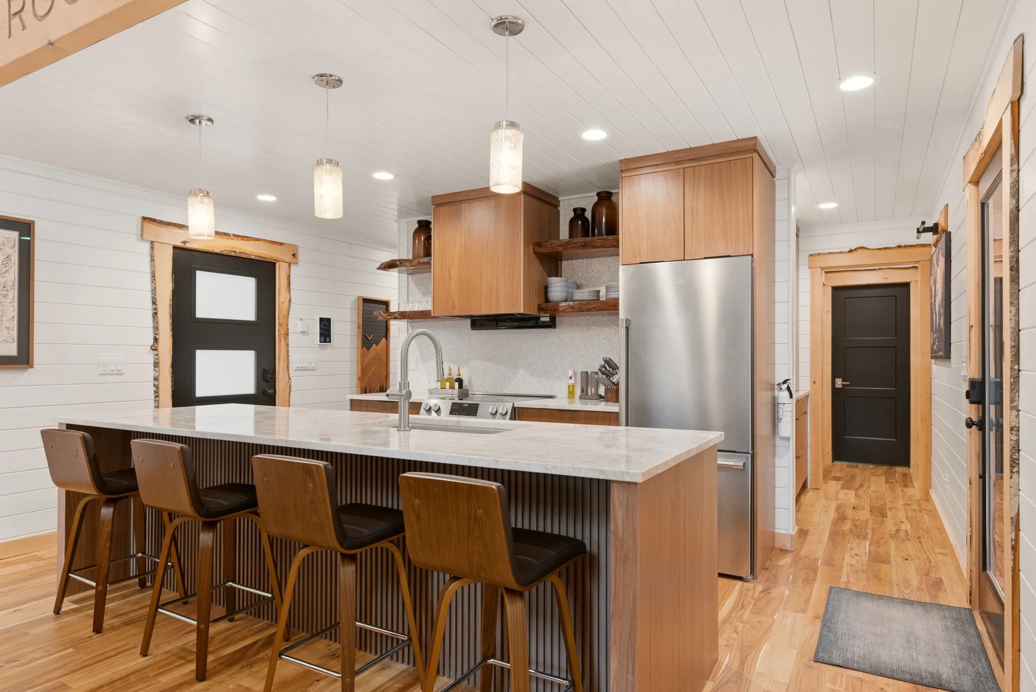 Taj Mahal quartzite countertops and walnut cabinetry in Fjellsangin's kitchen near Mount Rainier