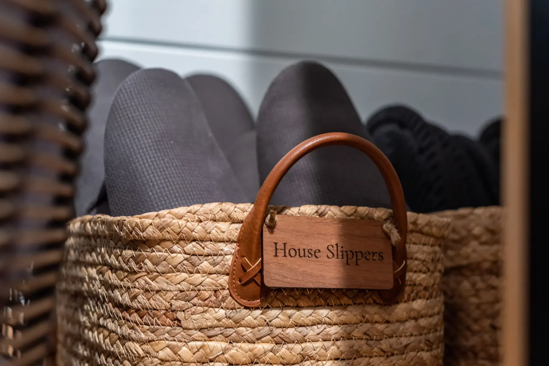 Basket of house slippers provided for guests at Fjellsangin, a Nordic cabin retreat in Ashford WA