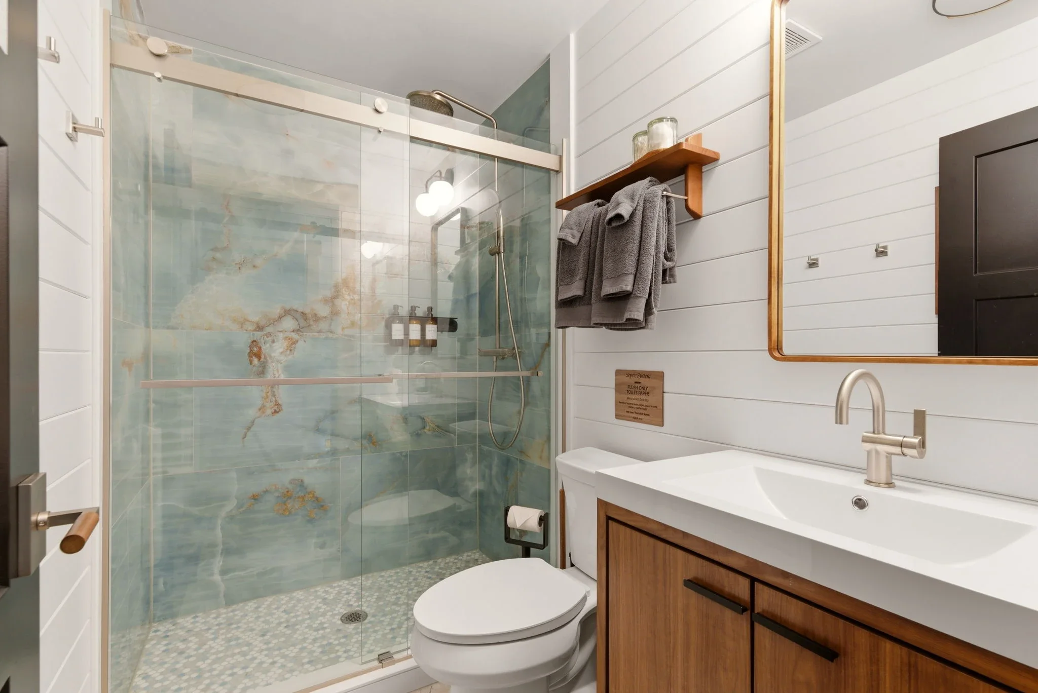 Upper bathroom vanity with walnut cabinets at Fjellsangin cabin
