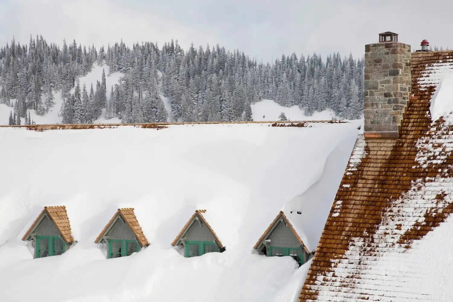 Snow-buried Paradise Inn roofline at Mount Rainier National Park in winter — snowshoeing season near Ashford WA