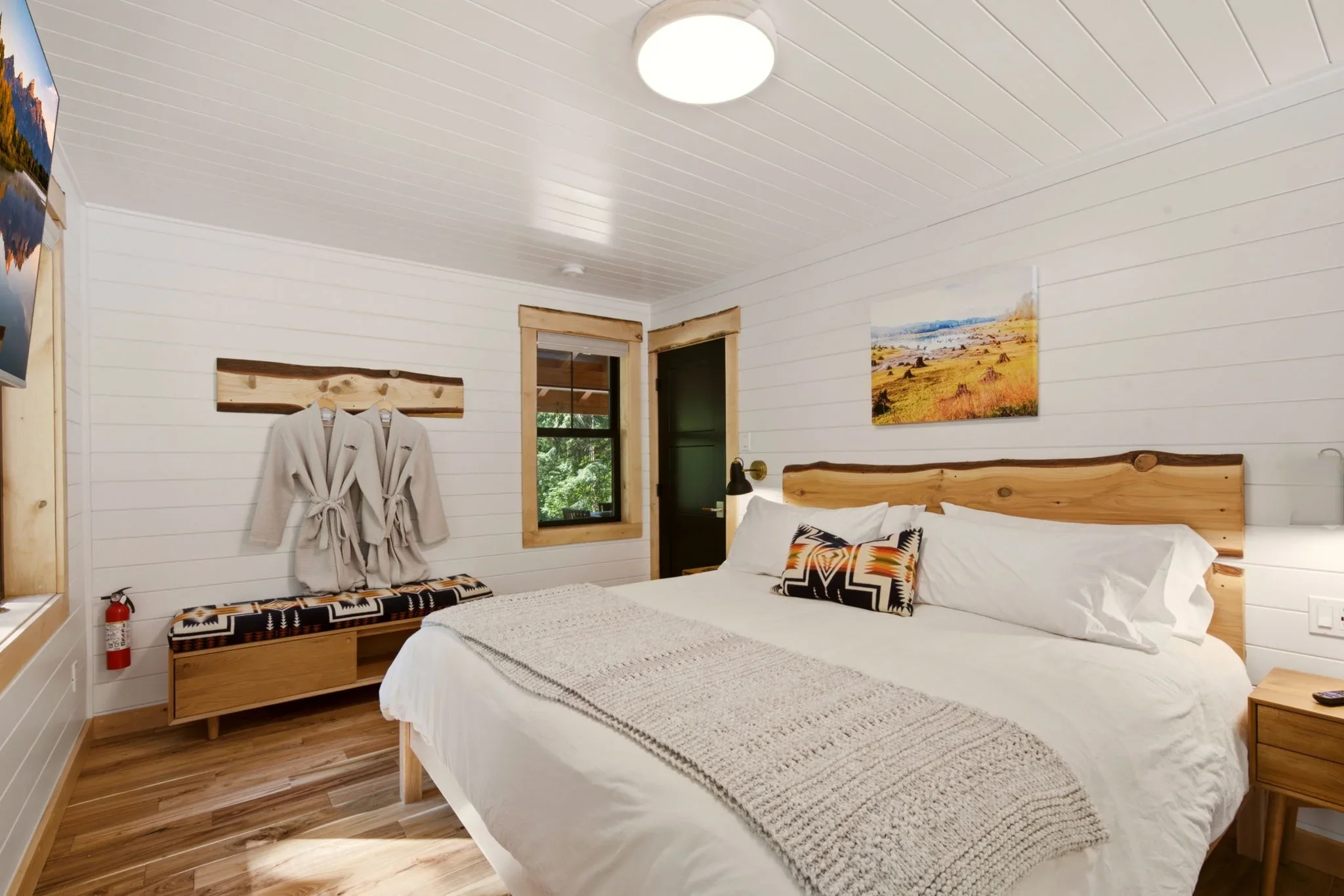 Plush robes on cedar peg rack above Pendleton bench in Fjellsangin main-floor bedroom near Mount Rainier