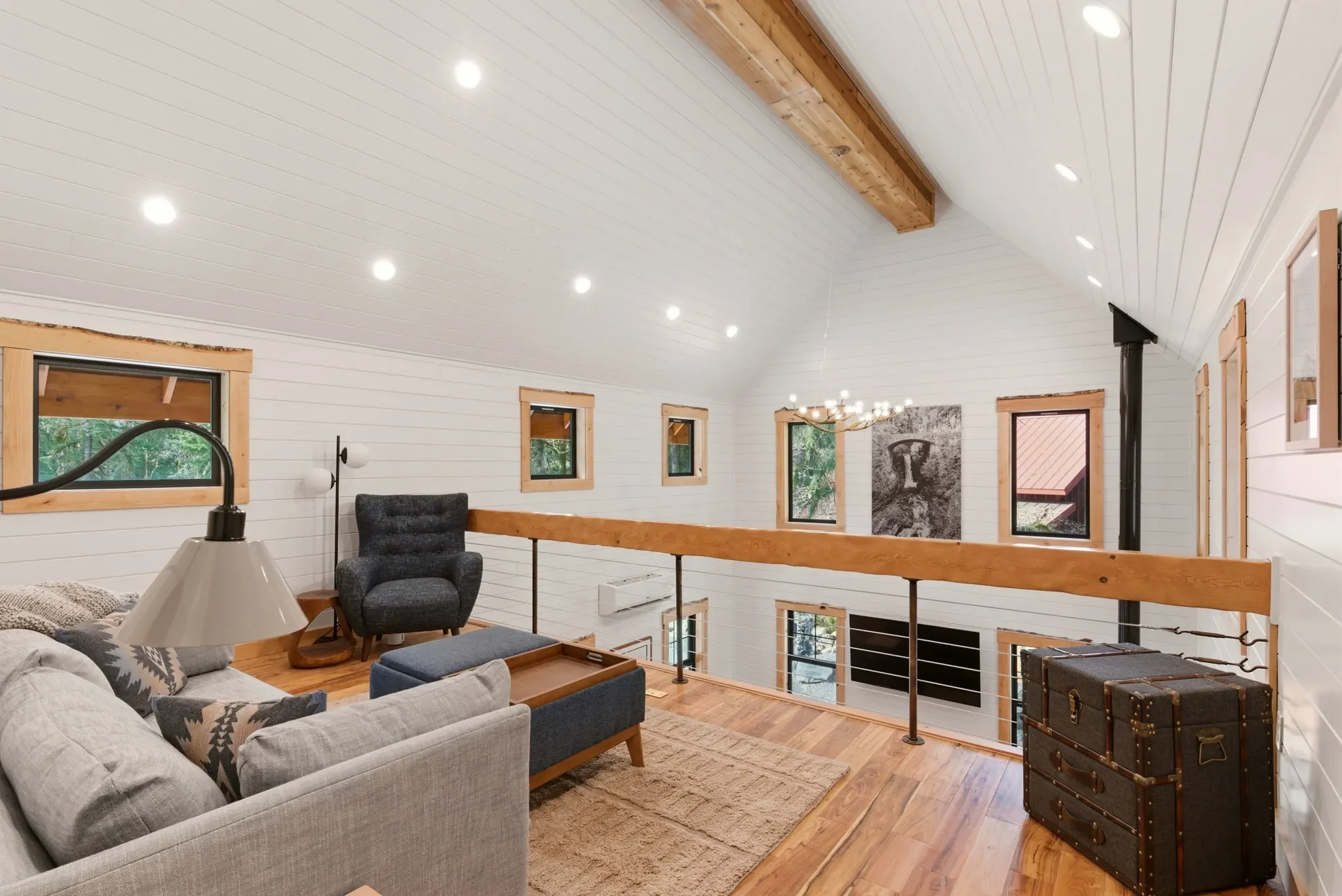 Loft overview with queen sleeper sofa and reading area at Fjellsangin cabin