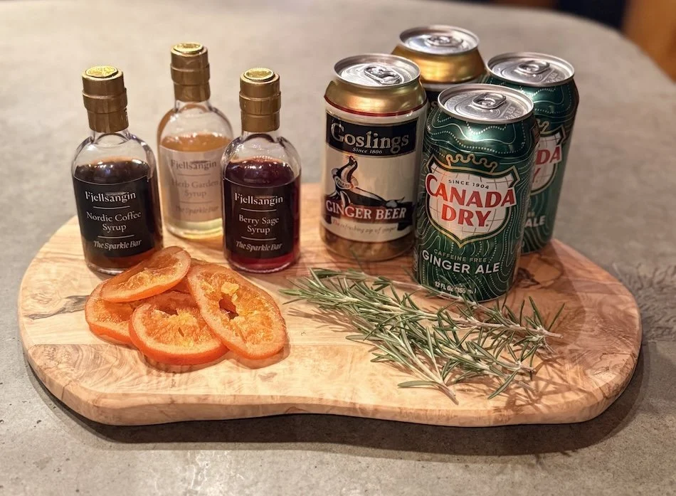 A photo of fjellsangin syrups, candied oranges and mixers.