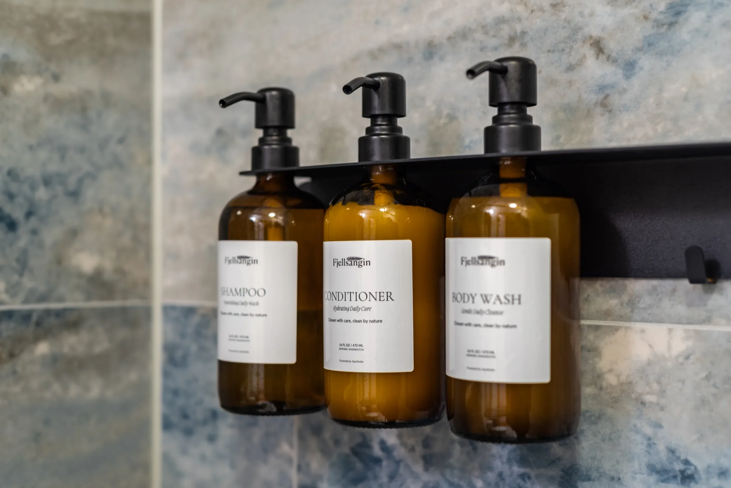 Refillable Apotheke amenities in the shower bedroom at Fjellsangin cabin near Mount Rainier
